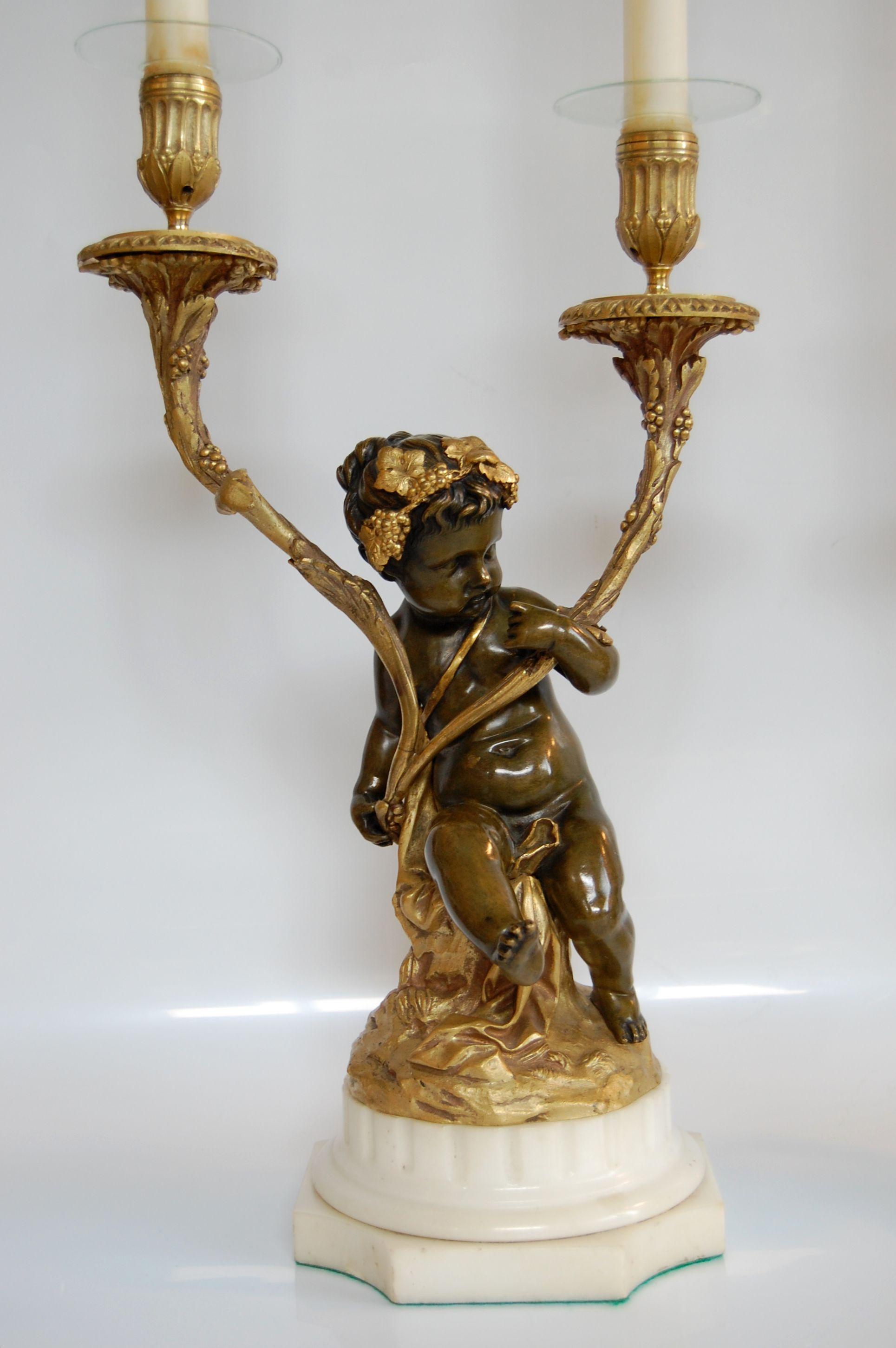 This pair of gilt and patinated candelabra are in excellent condition and make quite a statement. The finish on both the metal and marble are in excellent condition. Originally wired, it has since been removed for candle burning, but can be