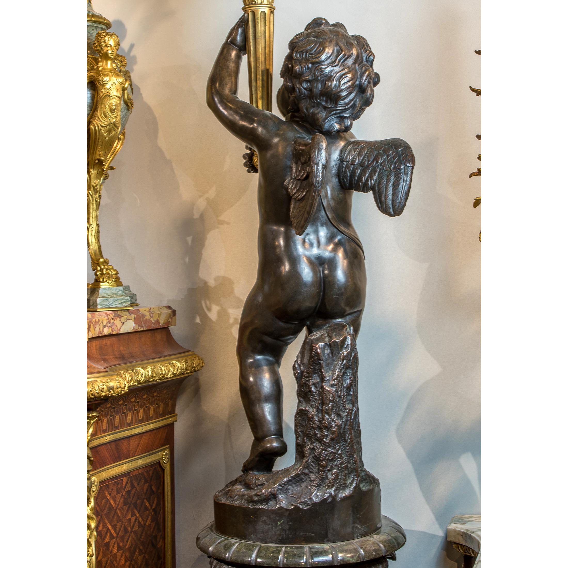 Pair of Gilt and Patinated Bronze Putti Torchères and Marble Pedestals In Good Condition For Sale In New York, NY