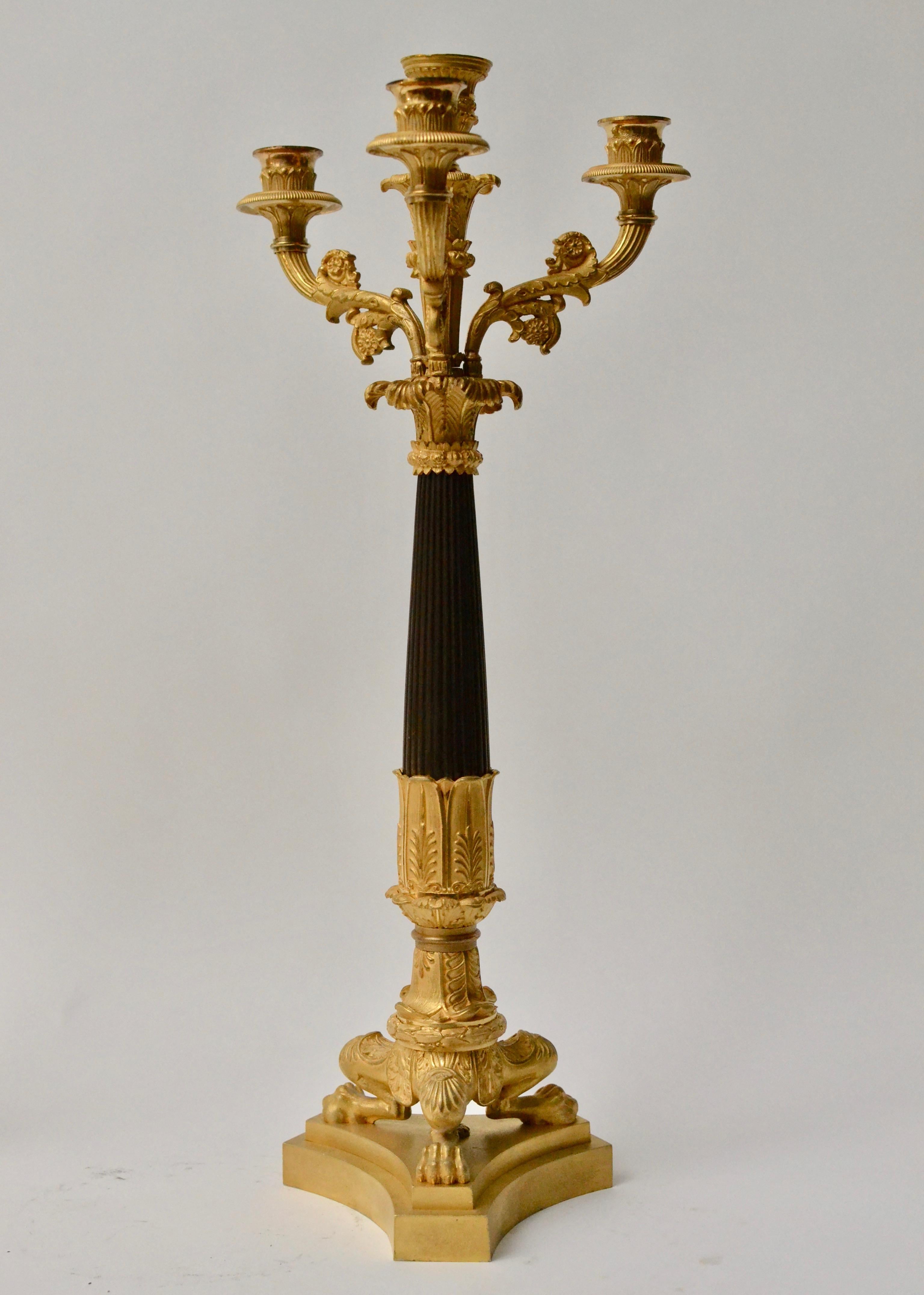 A pair of gilt and patinated empire candelabra, French, circa 1825.