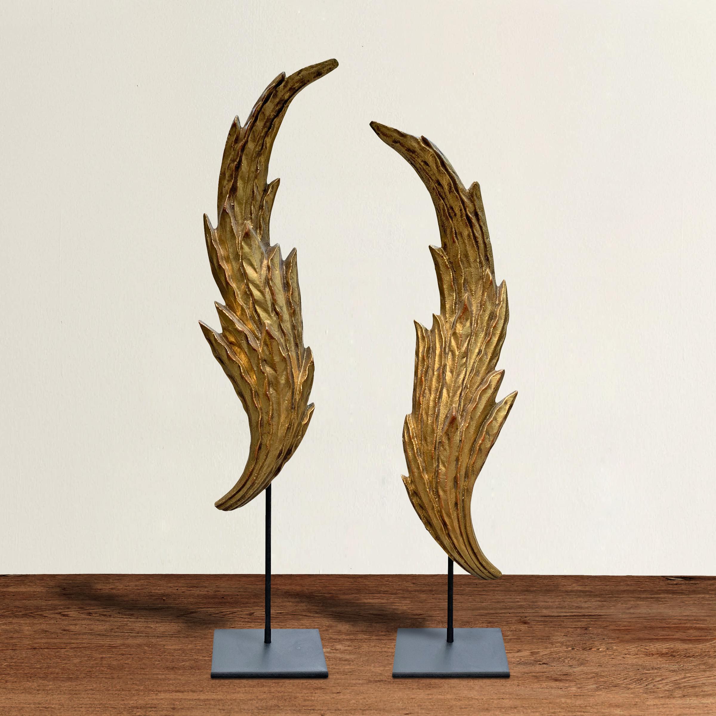 A wonderful pair of mid-20th century American neoclassical style gilt metal laurel leaf architectural fragments, mounted on custom steel stands.