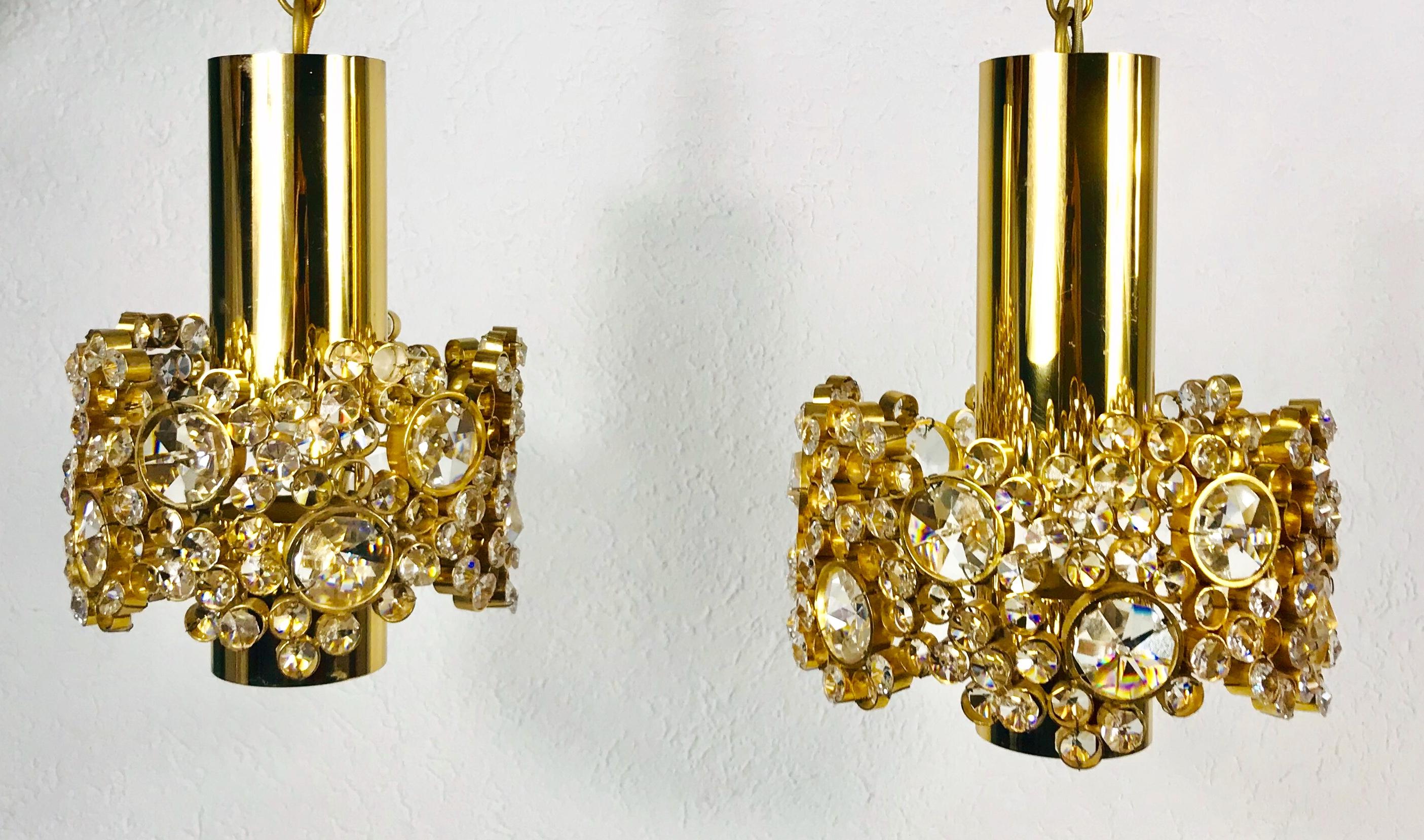An extraordinary pair of pendant lamps by Palwa made in Germany in the 1970s. The lamps have a very elegant design. They are made in the period of Hollywood Regency. Round Gilt brass body with one E27 socket. The socket is surrounded with very