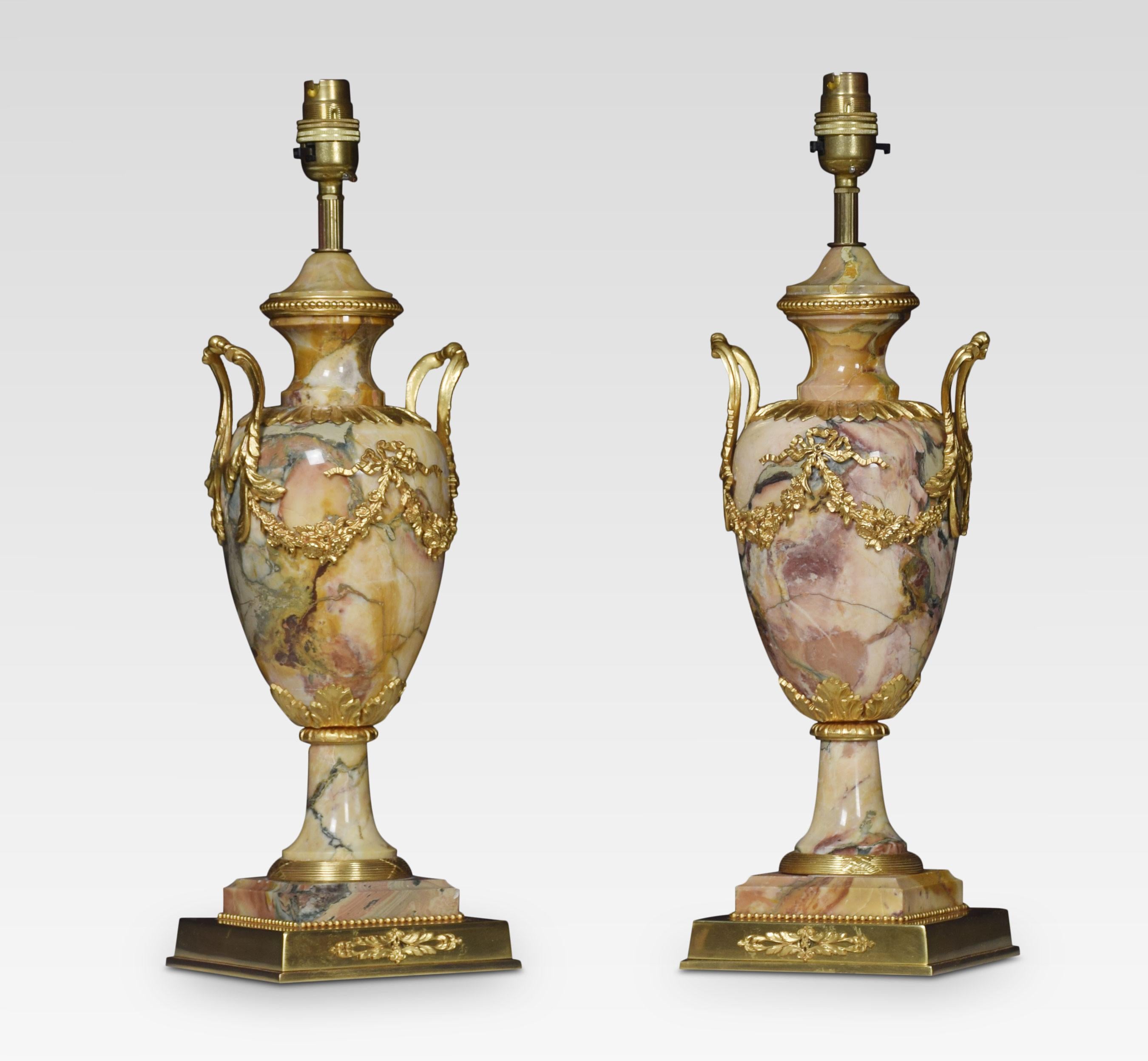 Pair of gilt brass and marble twin handle urn form table lamps, with ribbon tie and swag decoration. All raised up on square stepped bases. Each with domed silk shades. The lamps have been rewired and tested.
Dimensions of lamps without