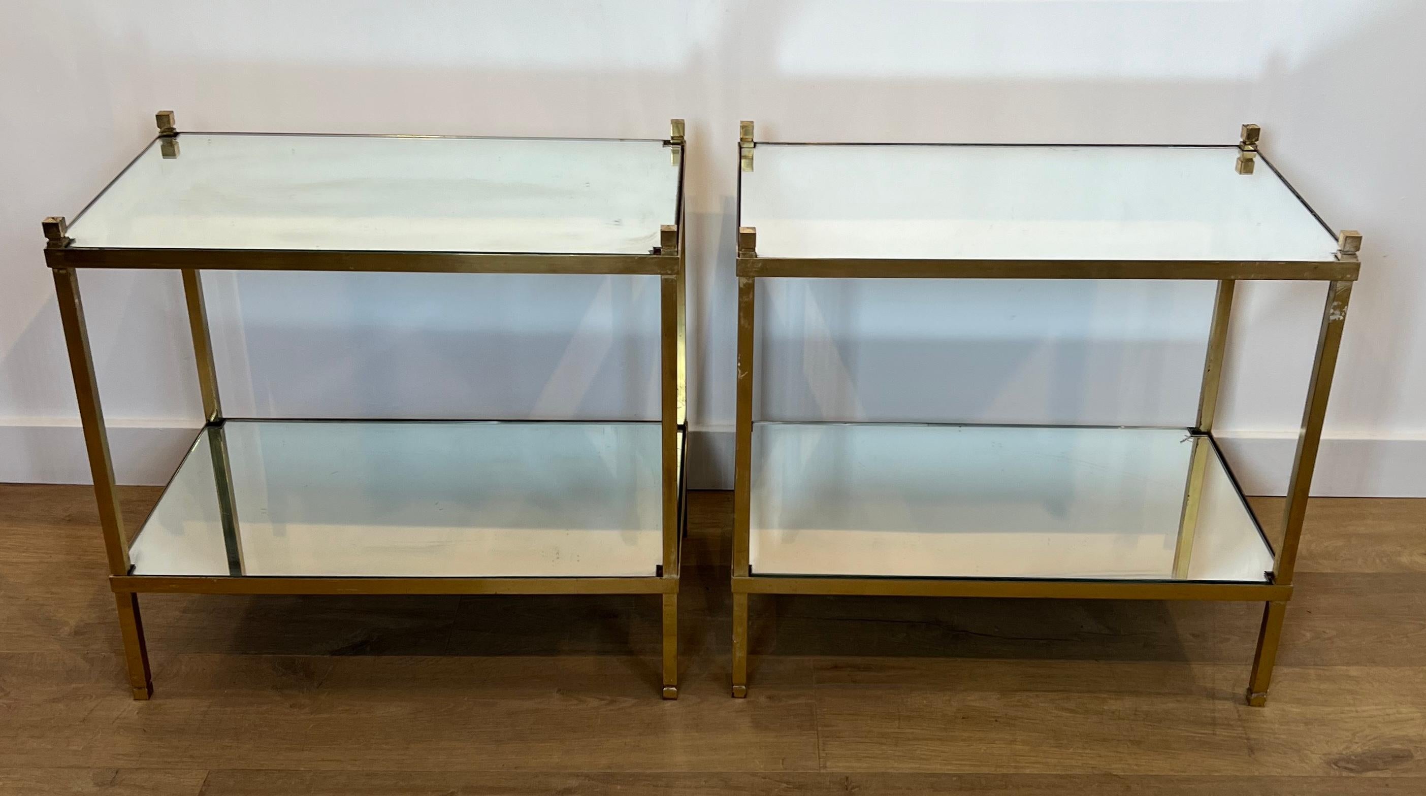 This nice pair of side tables is made of gilt brass with mirror tops. This is a French work. Circa 1970