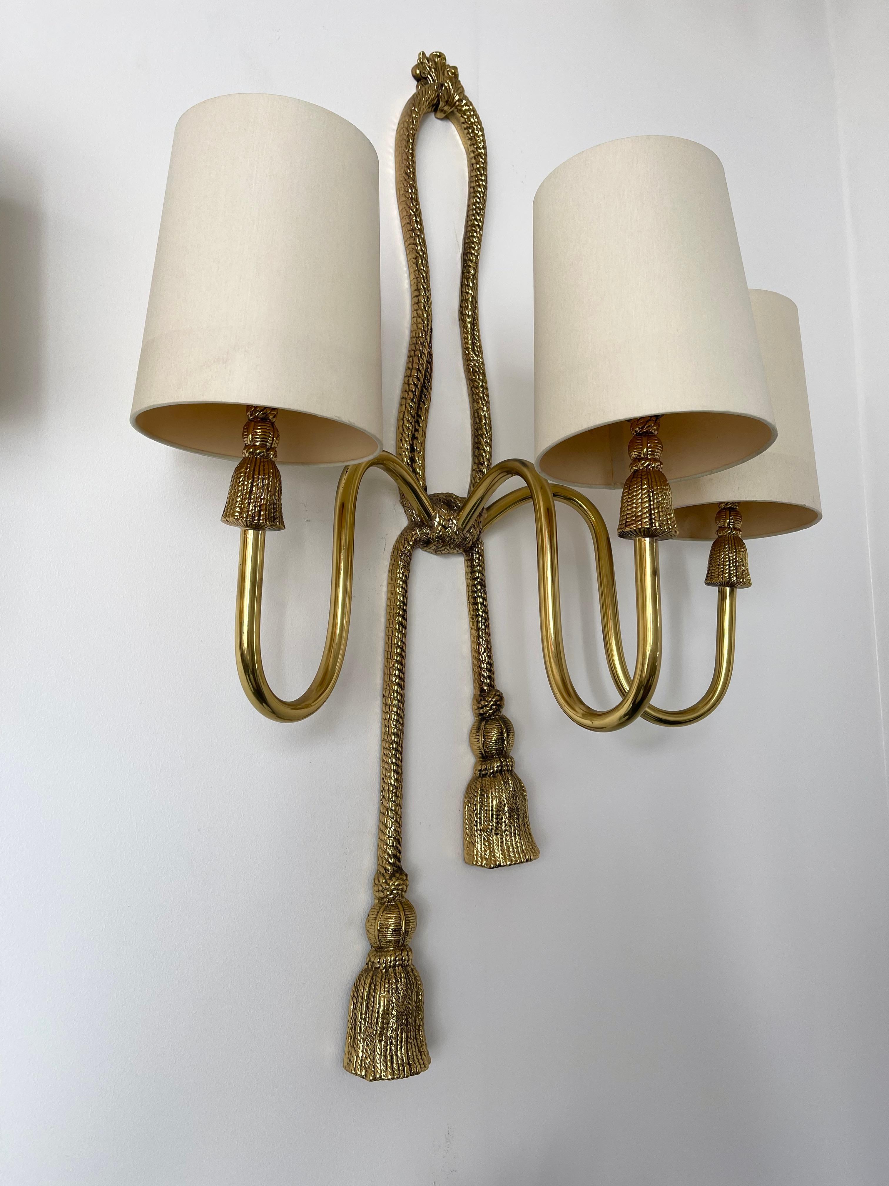 Rare large 3 lights neo classical bronze and brass Knot node Knod wall lights lamps lightning sconces by the manufacture Valenti. The sconces are delivered with NEW ivory cotton shades based on the original shades. Stamp Valenti Made in Spain on