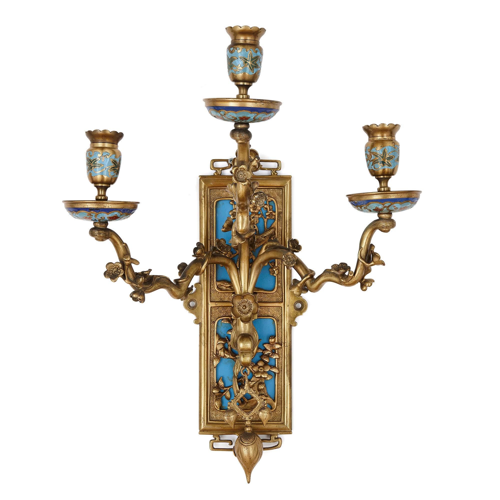 Pair of gilt bronze and enamel sconces in the Japonisme style
French, late 19th century
Measures: Height 48cm, width 38cm, depth 22cm

The sconces, or wall lights, in this pair are designed in the Japanese manner, the style—known as