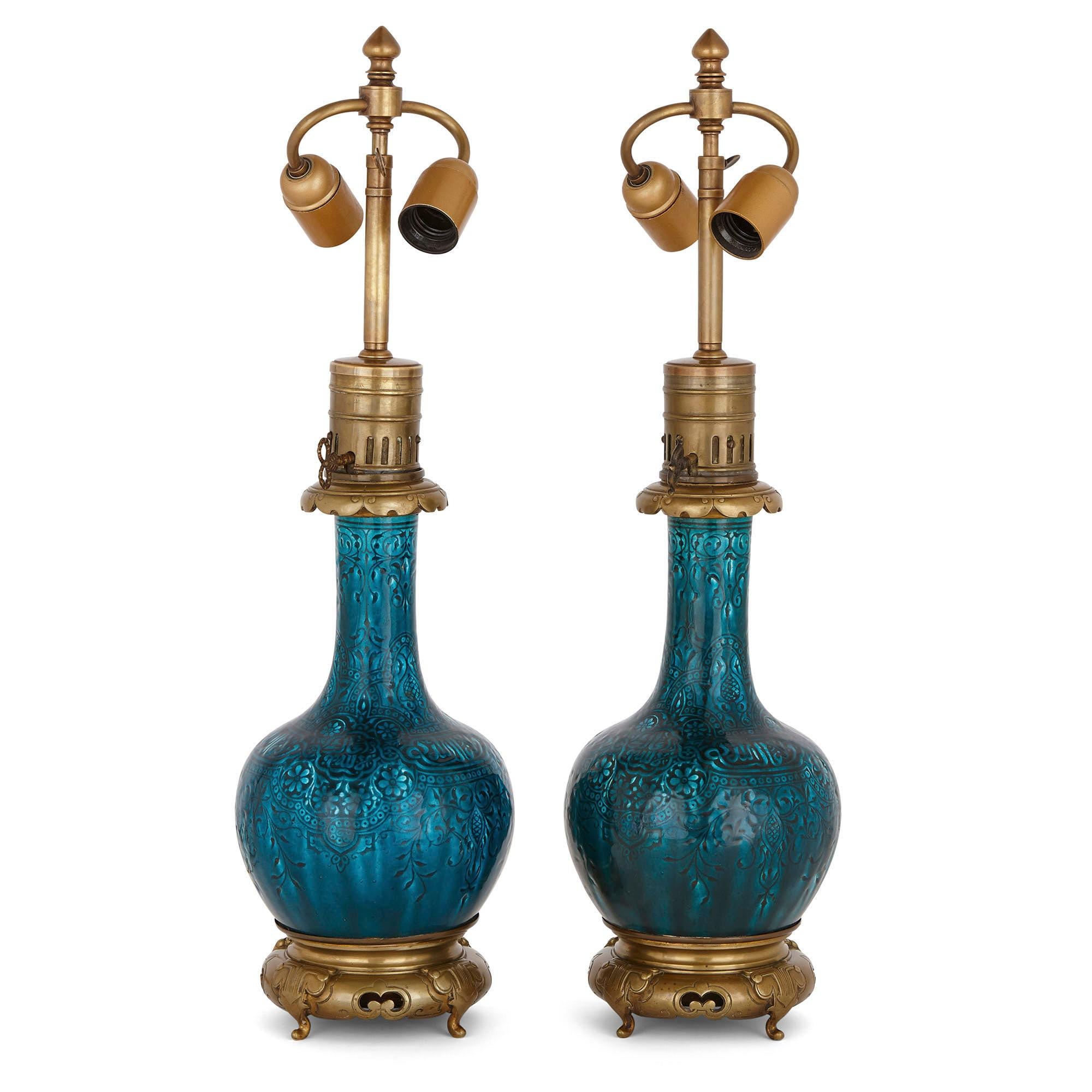 These beautiful table lamps have been attributed to Joseph-Théodore Deck, one of the most important ceramicists of the 19th century. Deck was the director of a prestigious faience workshop which was based in France. He was well known for his