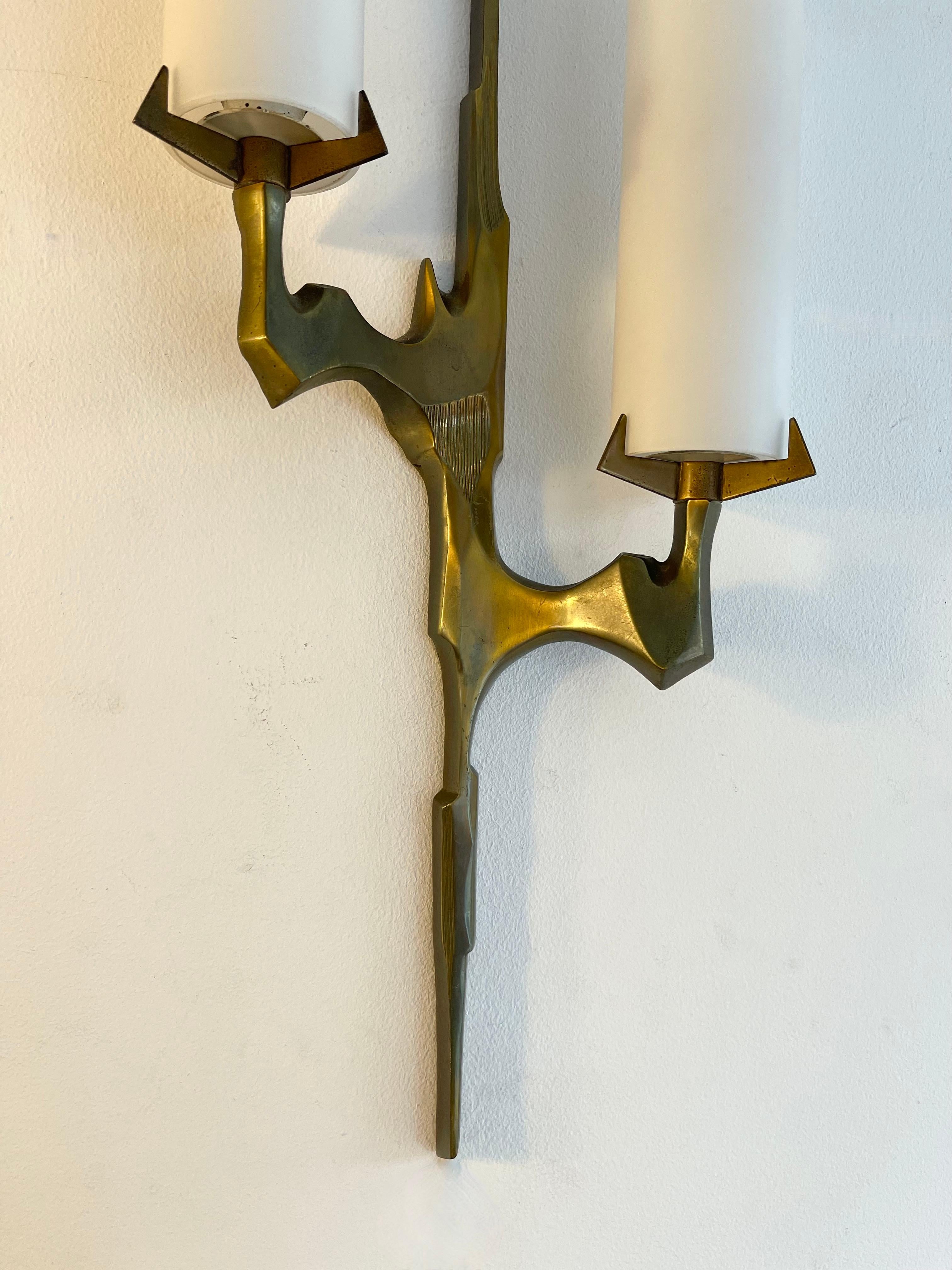 Mid-Century Modern pair of sconces or wall lights lamps by Maison Arlus. In cast gilt bronze and opaline glass. Rare model, nice patina. Original documentation on request. It’s a famous manufacture like Stilnovo, Arteluce, Arredoluce, Maison Jansen,