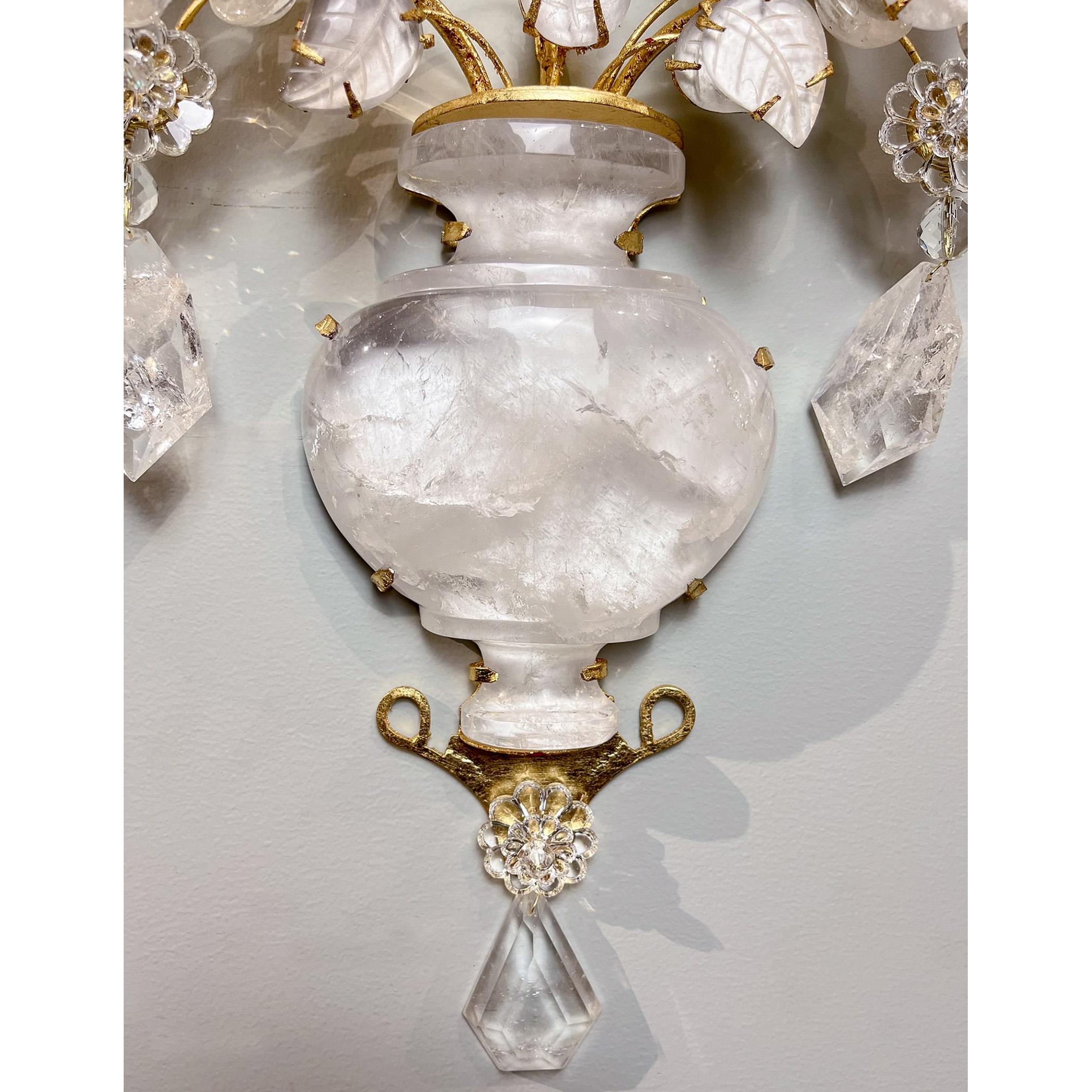Rock crystal sconce in the style of a vase full of flowers and foliage. The large bellied vase contains crystal foliage and four large rock crystal flowers. Leaf details are etched into the crystal while flowers are formed by individual cut rock