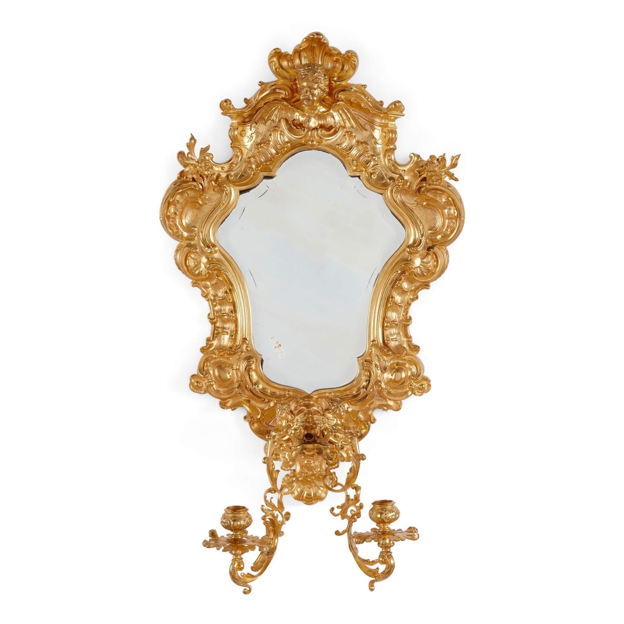 Pair of gilt bronze Baroque style wall appliques
French, late 19th Century
Height 68cm, width 39cm, depth 17cm

The appliques in this superb pair of works are wrought from gilt bronze in the Baroque style and feature mirrors and lights. Each