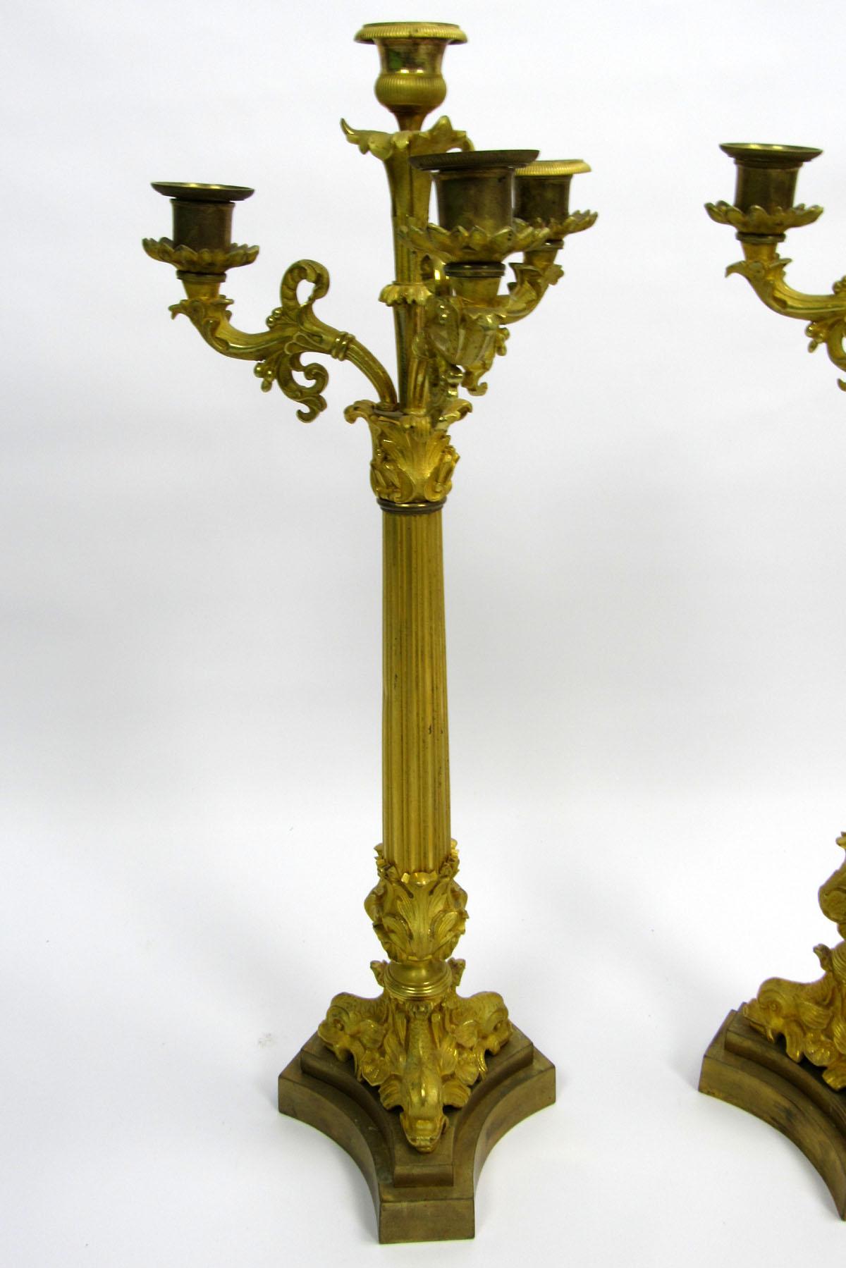 Pair of gilt bronze four-light candelabra with dolphins at the base.