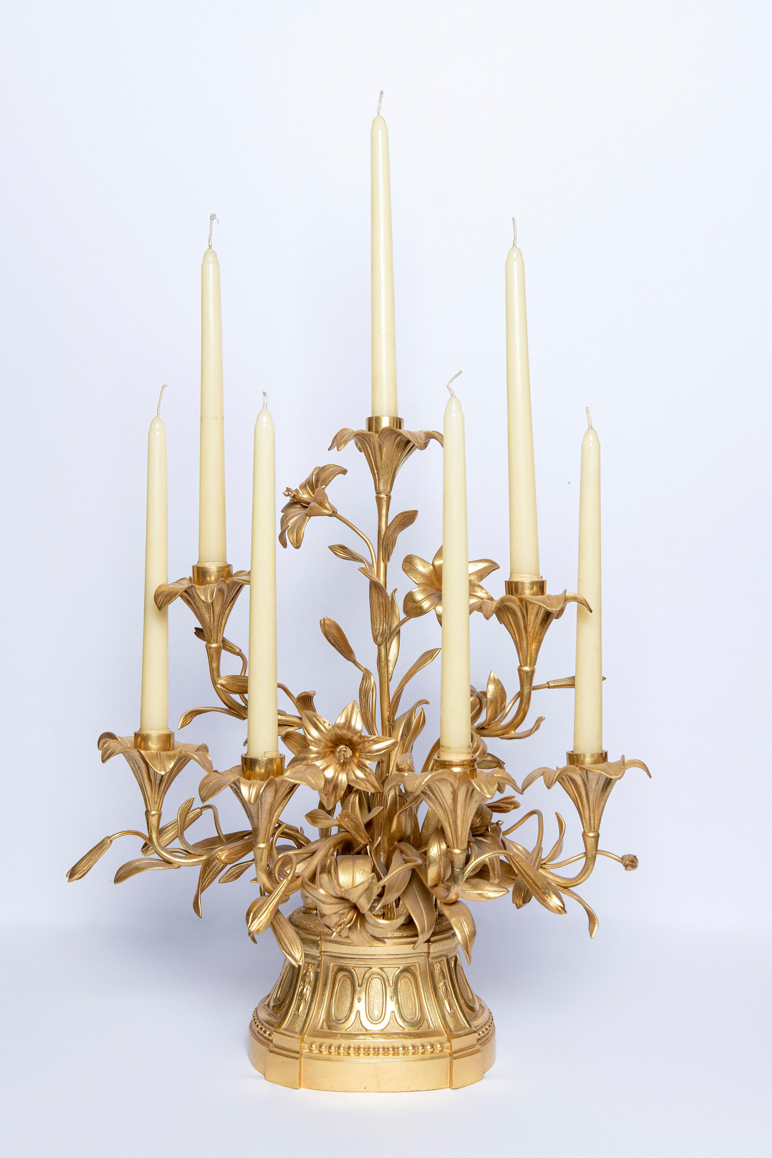 Pair of gilt bronze candelabras with flowers. France, late 19th century.