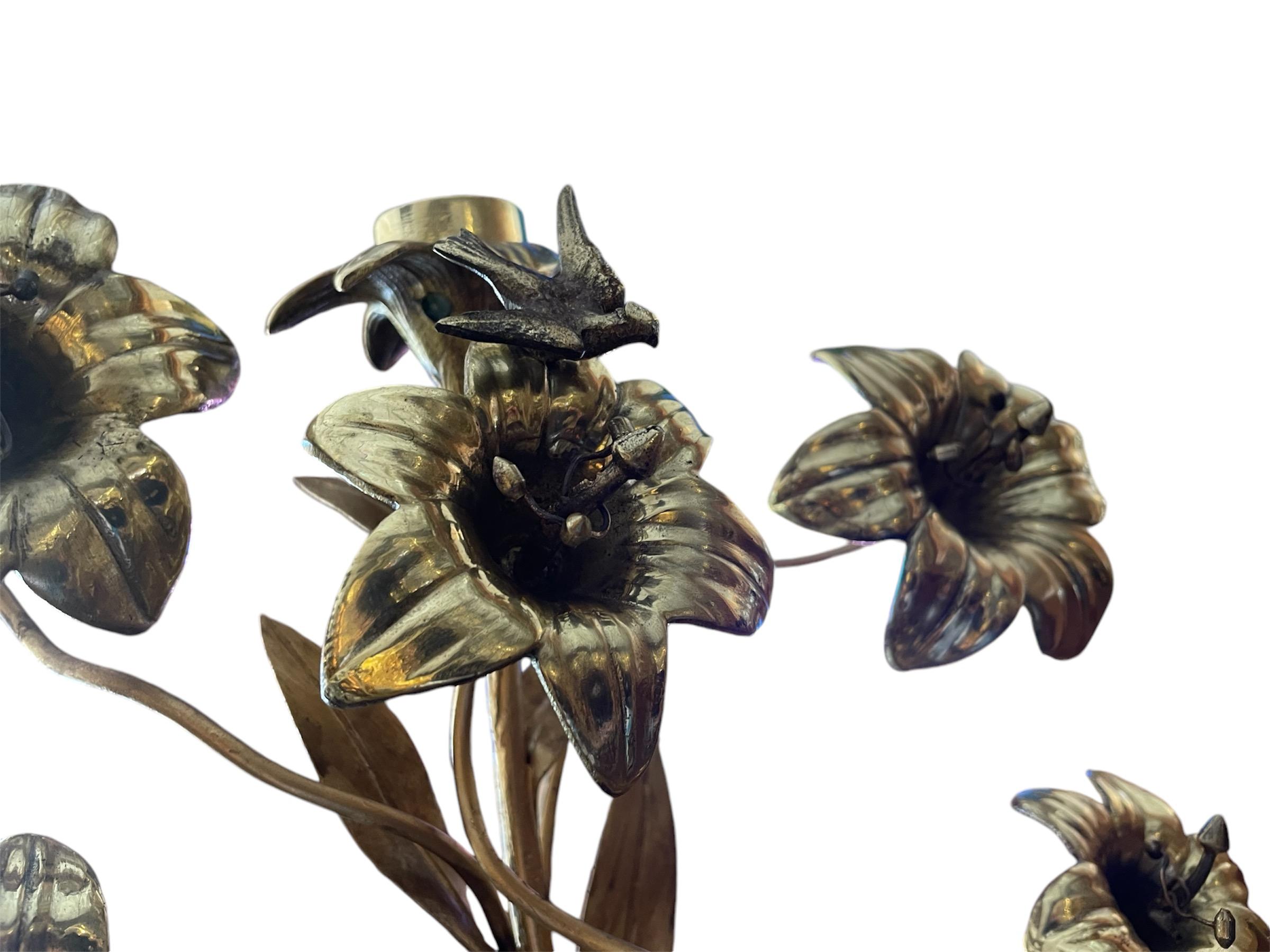 This is a 19th Century Pair of Gilt Bronze Console Lily Flowers Candelabras. It depicts a bunch of gilt bronze long branches of Lily flowers arranged as a bouquet and supported by a gilt bronze urn vase like. Seven Lily flowers in each candelabra