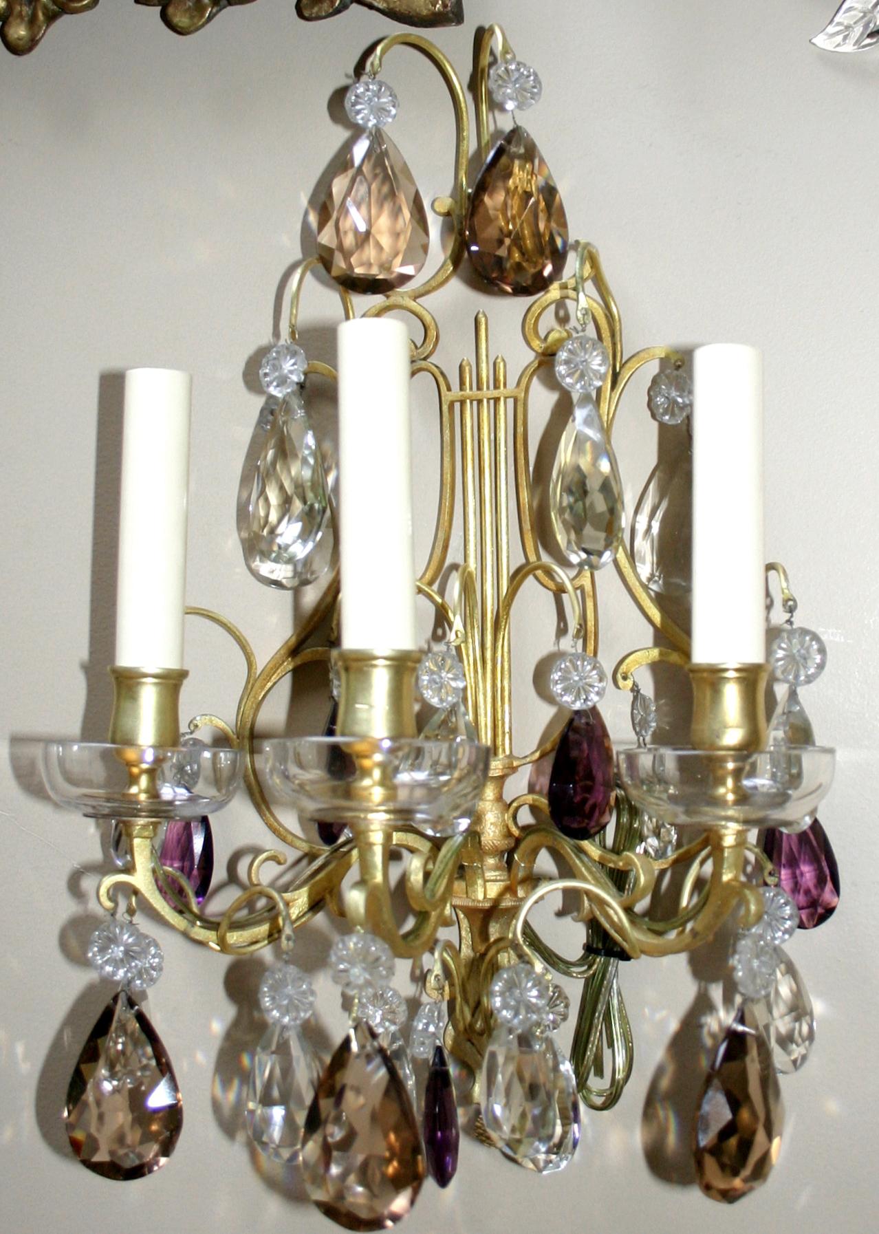 Pair of circa 1920's French three-light gilt bronze and crystal sconces.

Measurements:
Height: 16.5