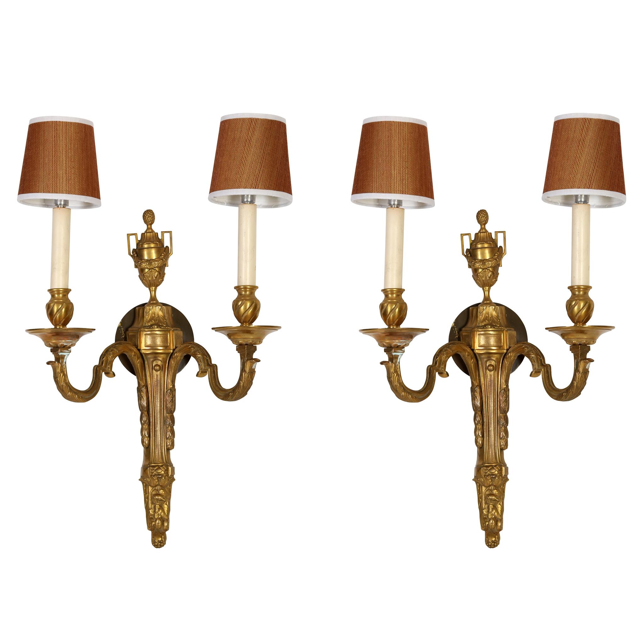These Louis XVI style gilt bronze double arm sconces, exude timeless elegance and opulence. Crafted with attention to detail, these sconces epitomize the grandeur and refinement of the late 18th-century French aesthetic. Each sconce features