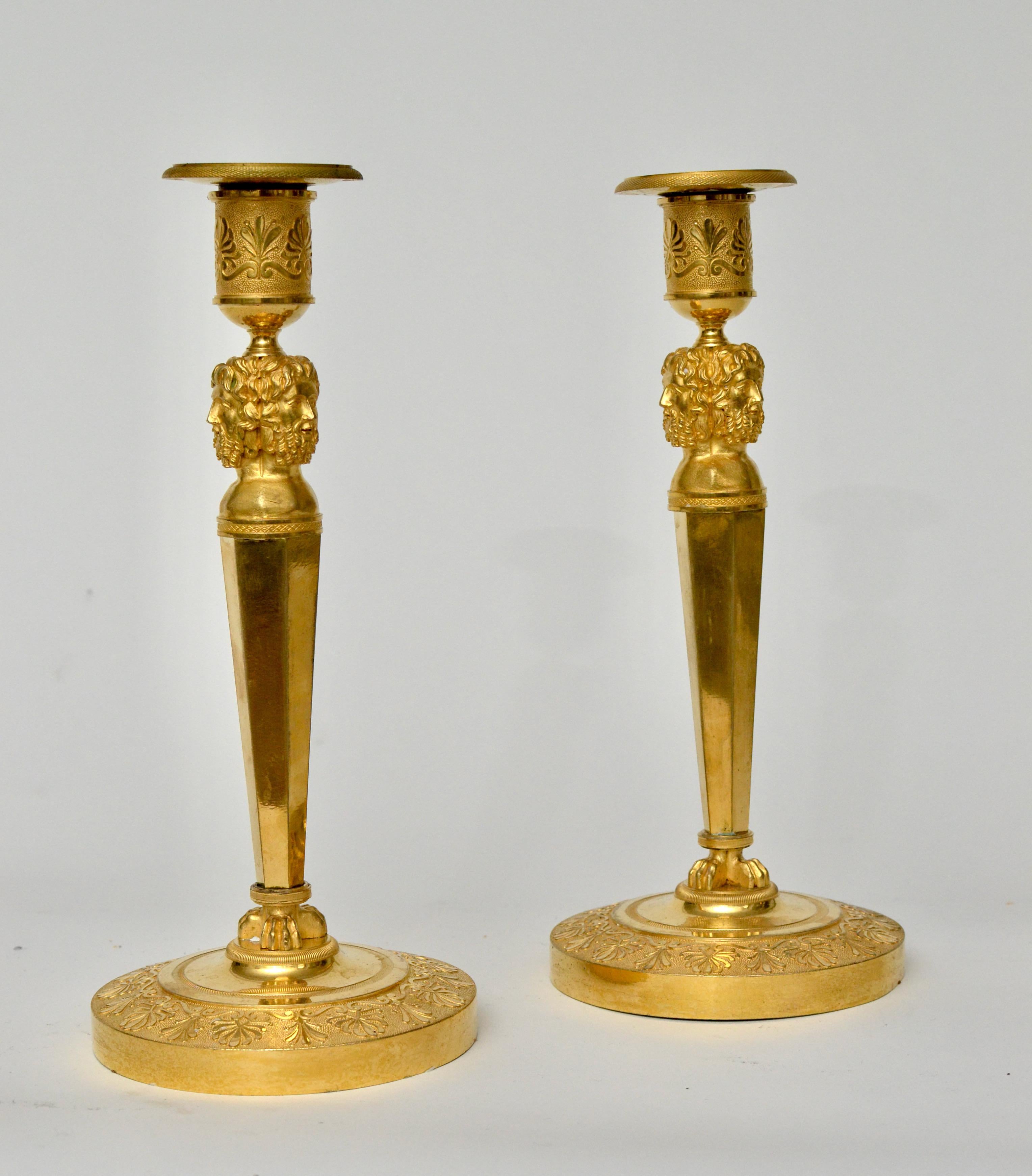 A very fine pair of French gilt bronze Empire candlesticks, Paris circa 1805-1810. The three figural heads on each candlestick is probably that of Homer.
Homer is the presumed author of the Iliad and the Odyssey, two epic poems that are the