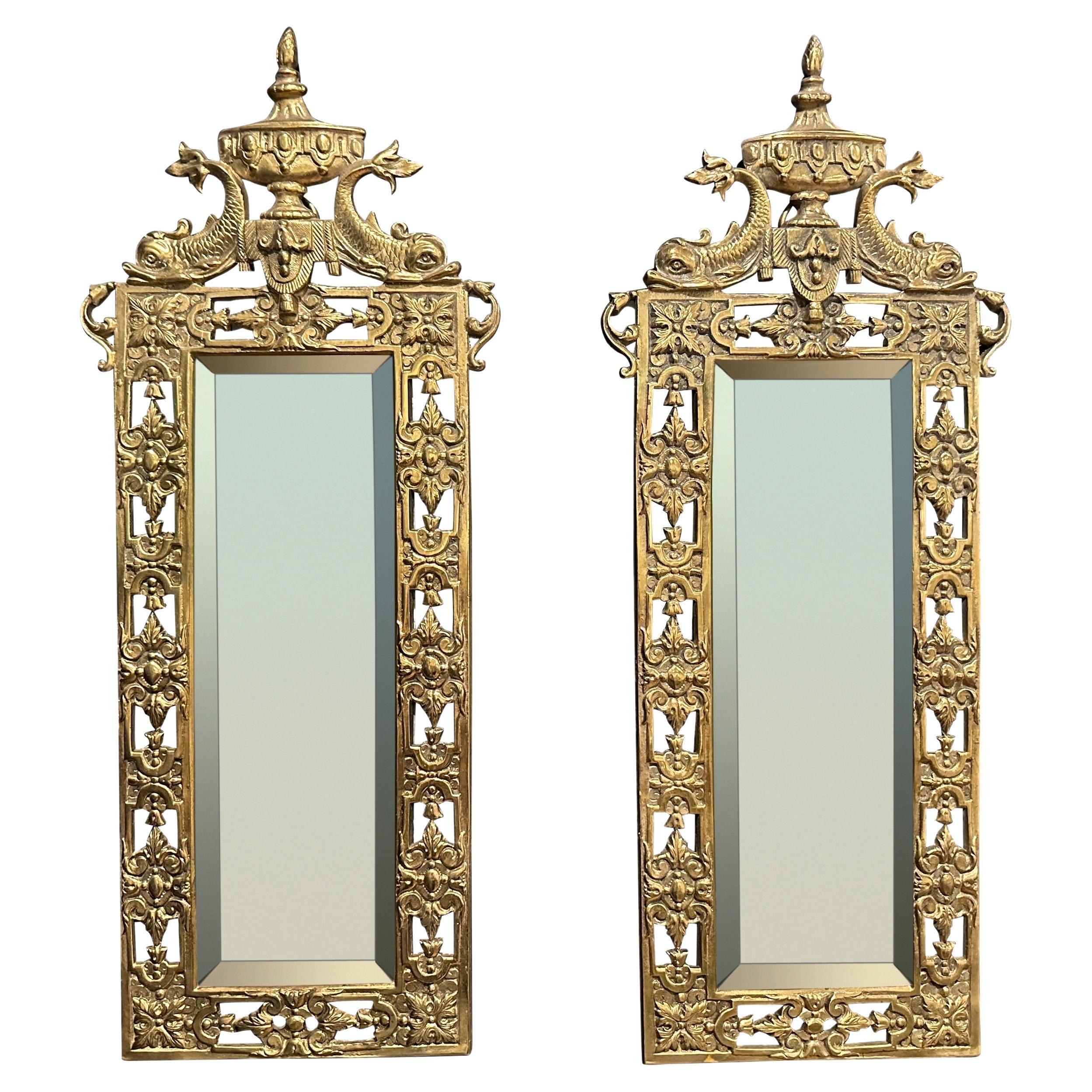 Paire de miroirs en bronze doré avec dauphins et urne en vente