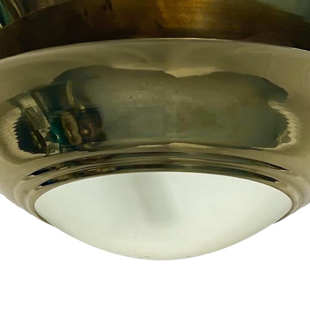 A pair of circa 1960's French gilt light fixtures with frosted glass inset and four interior lights each. Sold individually.

Measurements:
Diameter: 19