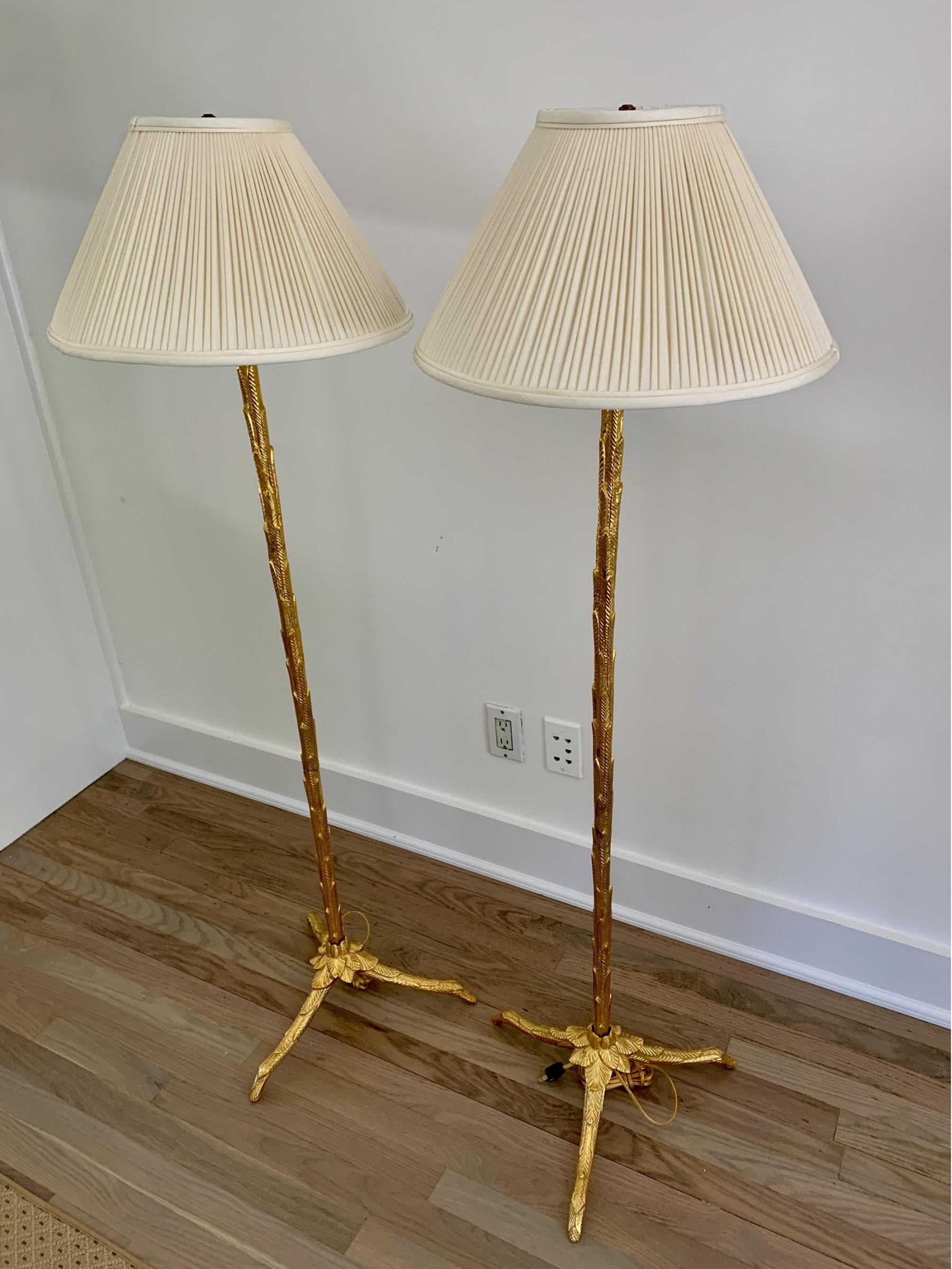 A fine pair of high quality solid gilt bronze floor lamps by Maison Baguès with palm leaf design, France, Circa 1960's.

Can be sold separately for $ 4,950 each.