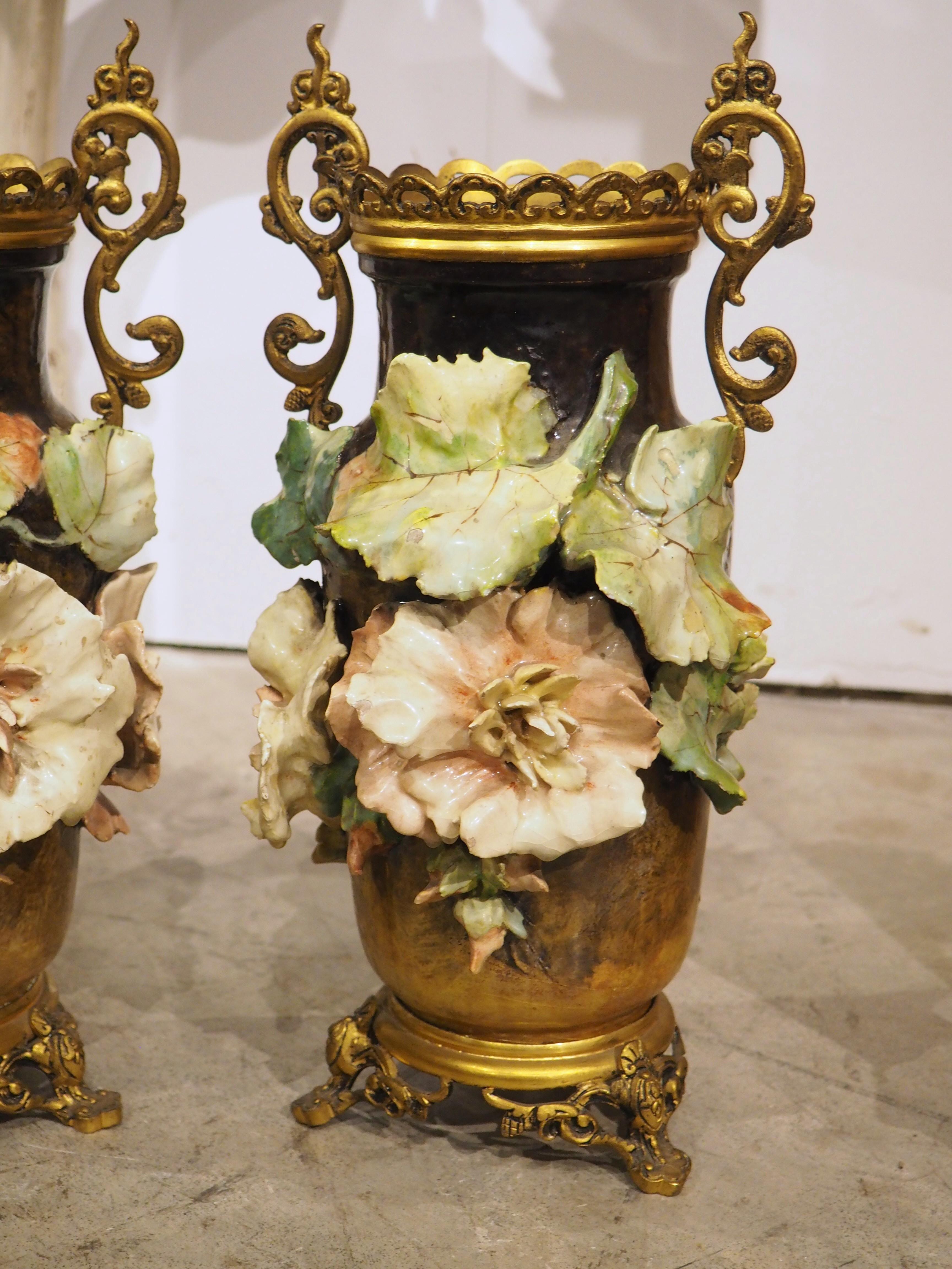 More information coming soon…

A stunning pair of French gros-relief barbotine vases from circa 1880, with gilt bronze handles and mounting.  The vases have a variegated ground, ranging from black to tan, which allows the eye-popping floral vines to