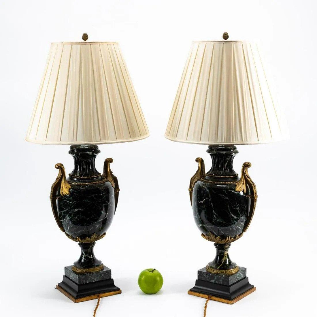 A Very important pair of gilt bronze mounted Vert des Alpes marble urns, now fitted as lamps in the Louis XVI taste, on socle plinths with square bases. France, circa 1920. Dimensions: 21