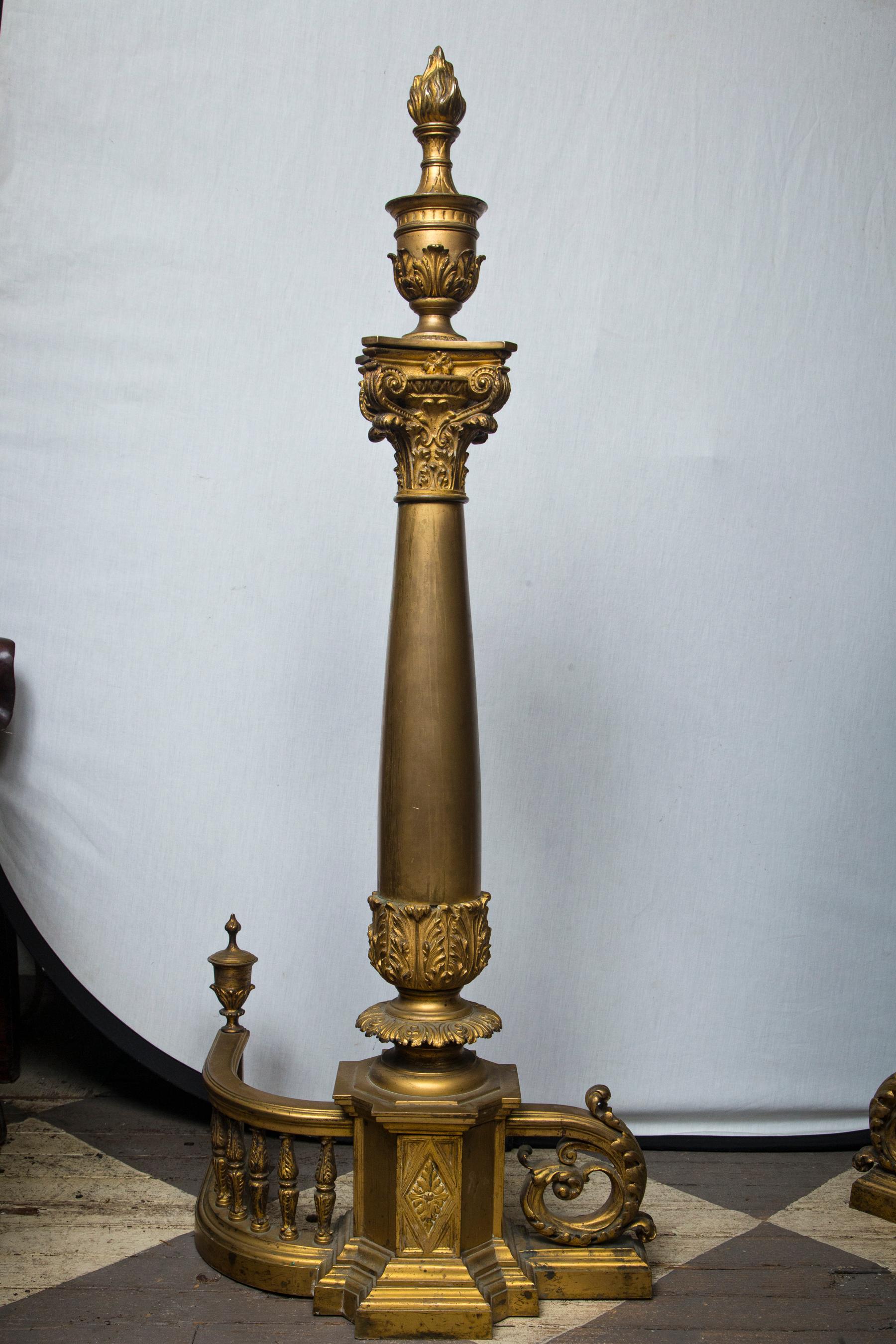 Baluster gate base that is 7.5 inches tall, centered by an 8 sided element that is decorated with a large diamond shape surrounding aa acanthus leaf design. Thick central column topped by a Corinthian capital which, in turn, is topped by a flame