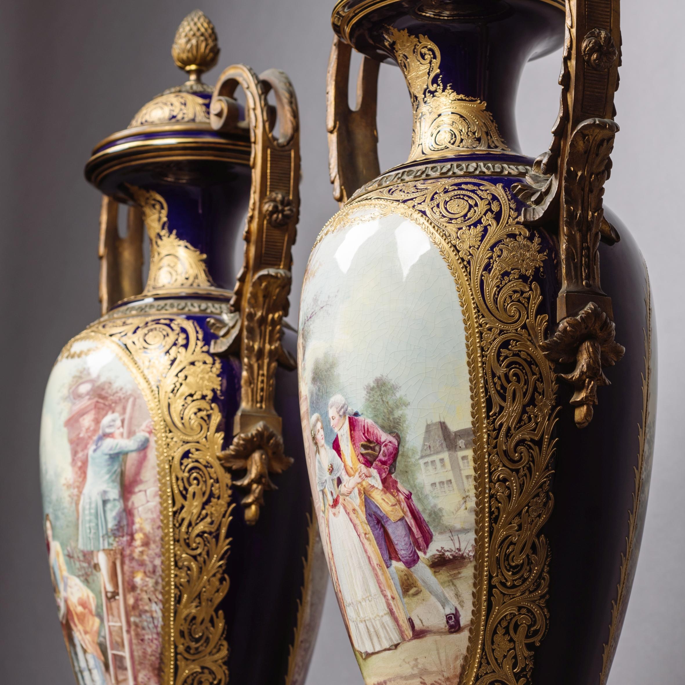A fine pair of gilt-bronze mounted cobalt blue Sèvres style porcelain vases and covers.

Each vase is of amphora form with domed covers, scrolled handles and square section re-entrant gilt-bronze plinth bases. The body of each vase is of cobalt