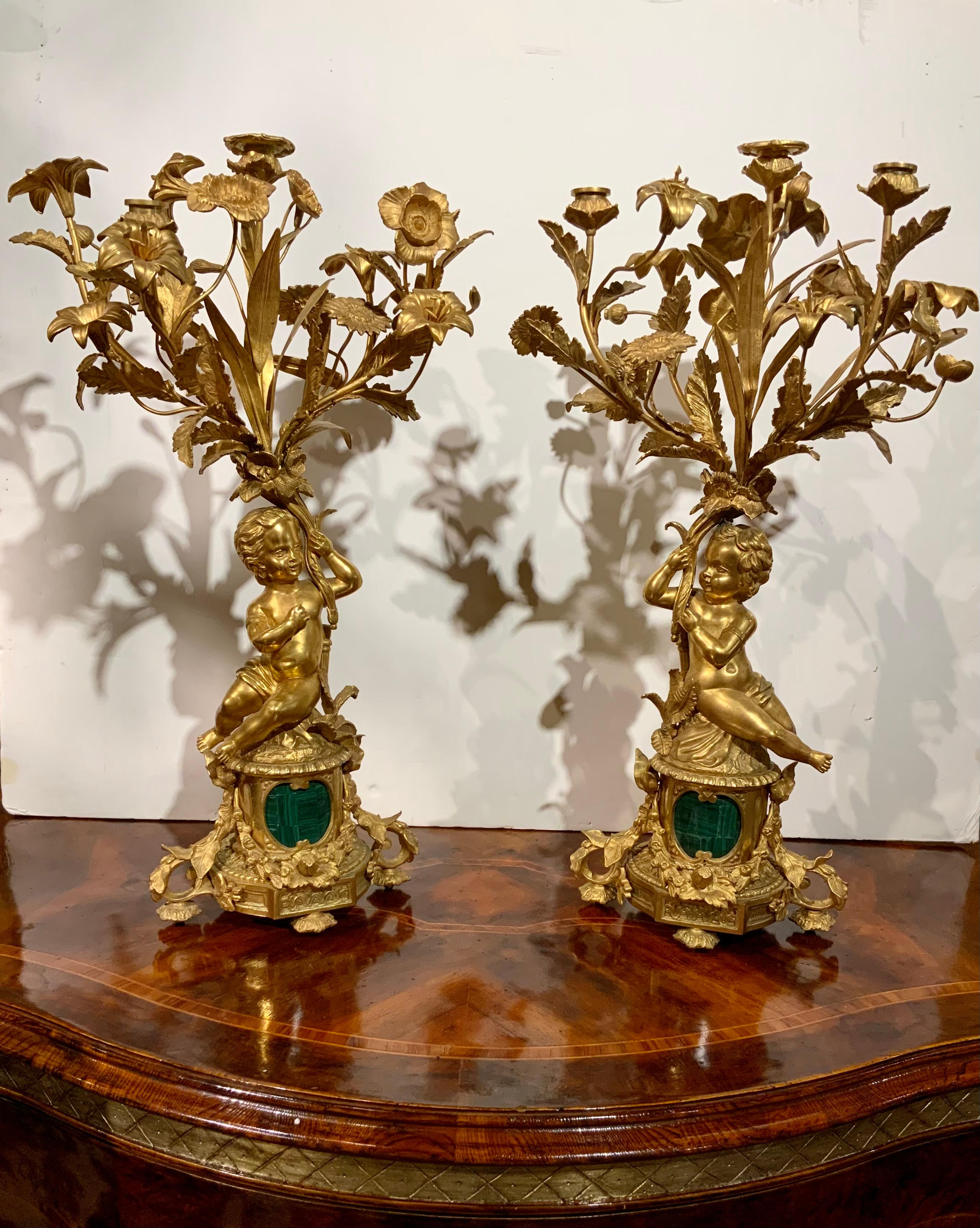 This pair of gilt bronze candleabrum are in fine condition with
The original bright gold patina. Each candleabrum has a gilt
Putti holding three branches holding three candleholders.
Each candleabrum has a multitude of winding branches and
Ending in