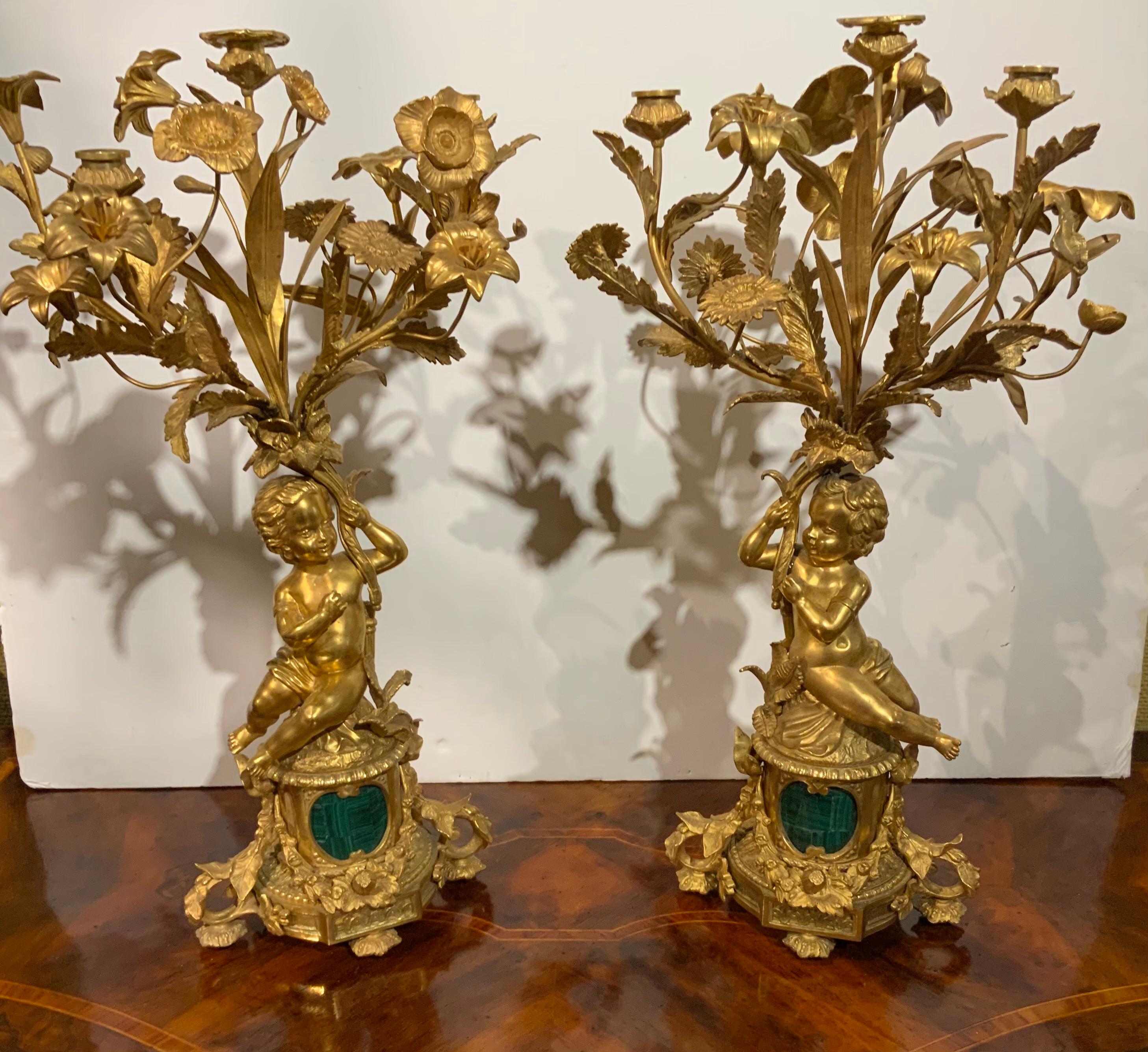 Bronze Pair of gilt bronze three lights each with putti, malachite centered at base For Sale