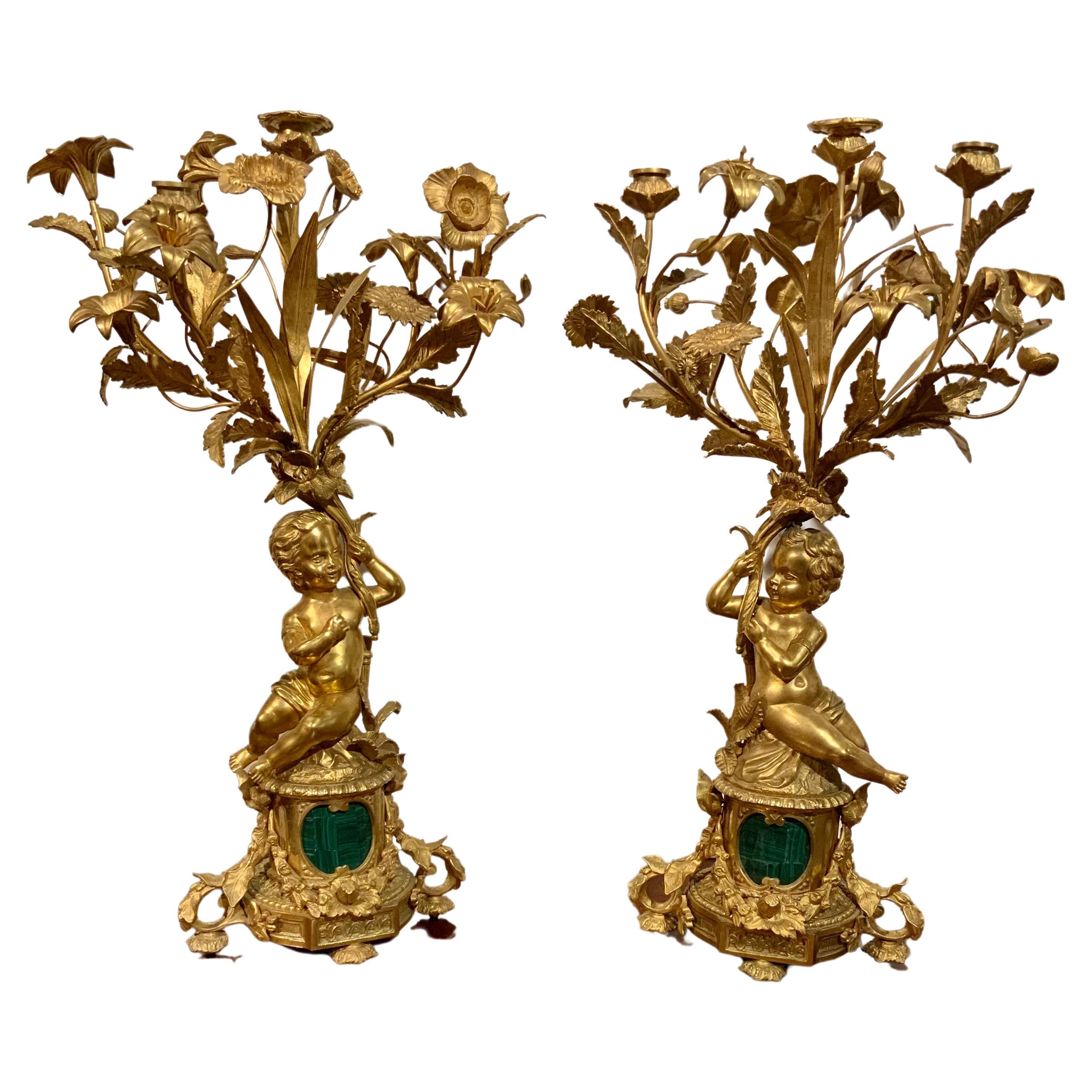 Pair of gilt bronze three lights each with putti, malachite centered at base For Sale