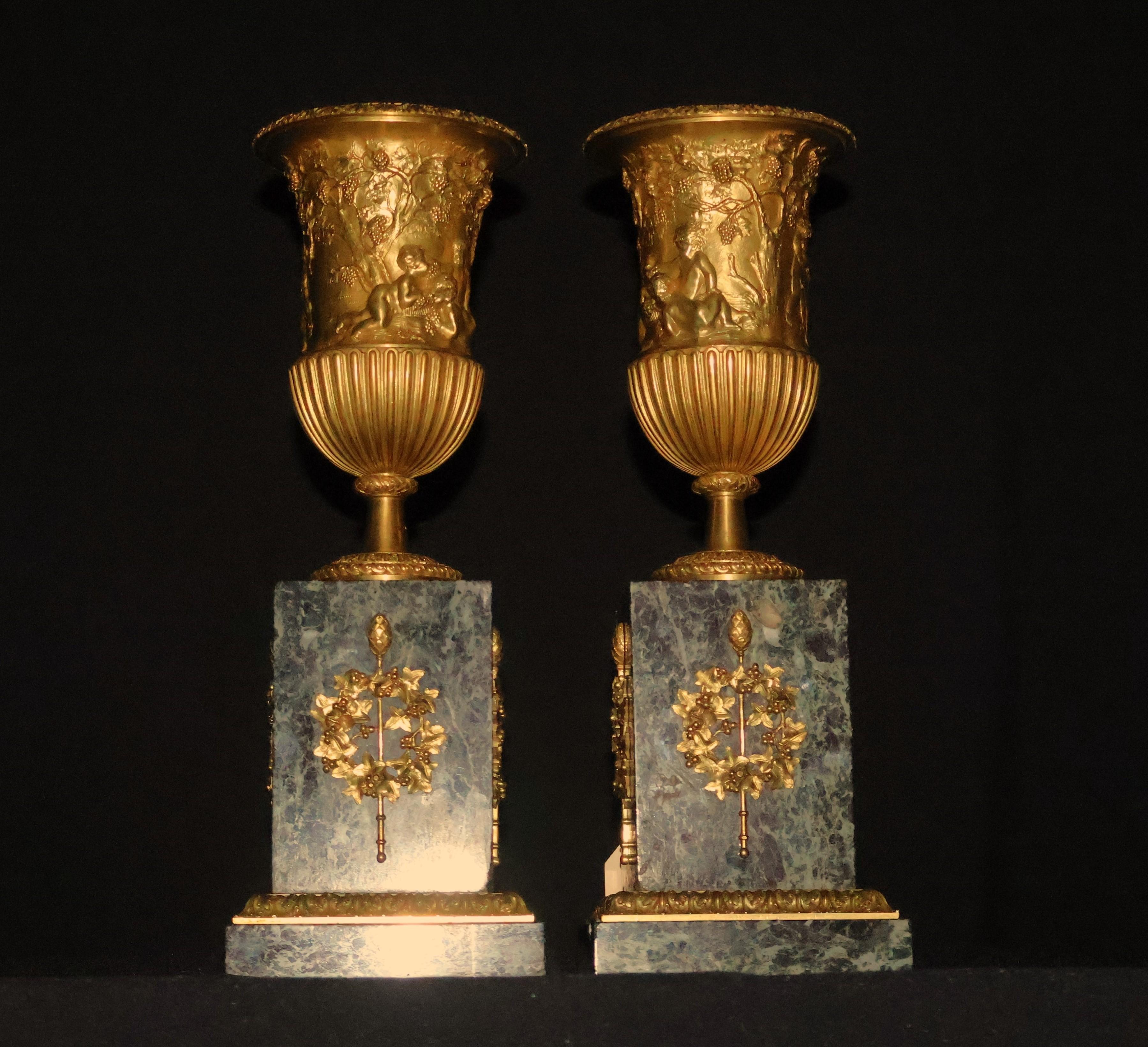 Pair of gilt bronze urns raised on a marble plinth with ormolu mounts (CW5595). The quality is superb, chasing is 10 on 10. France, circa 1870. Dimensions: Height 15 1/2