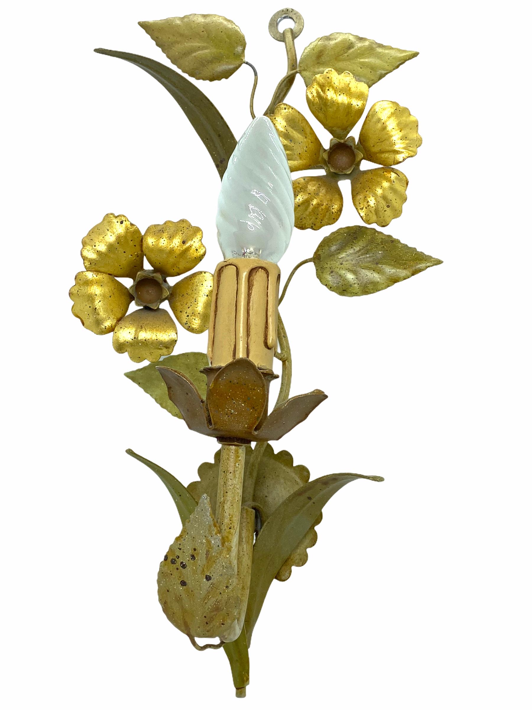 A pair of Hollywood Regency midcentury flower and leaf Florentine sconces, each fixture requires one European E14 candelabras bulb, up to 60 watts. The wall lights have a beautiful patina and give each room an eclectic statement. Polychrome frame