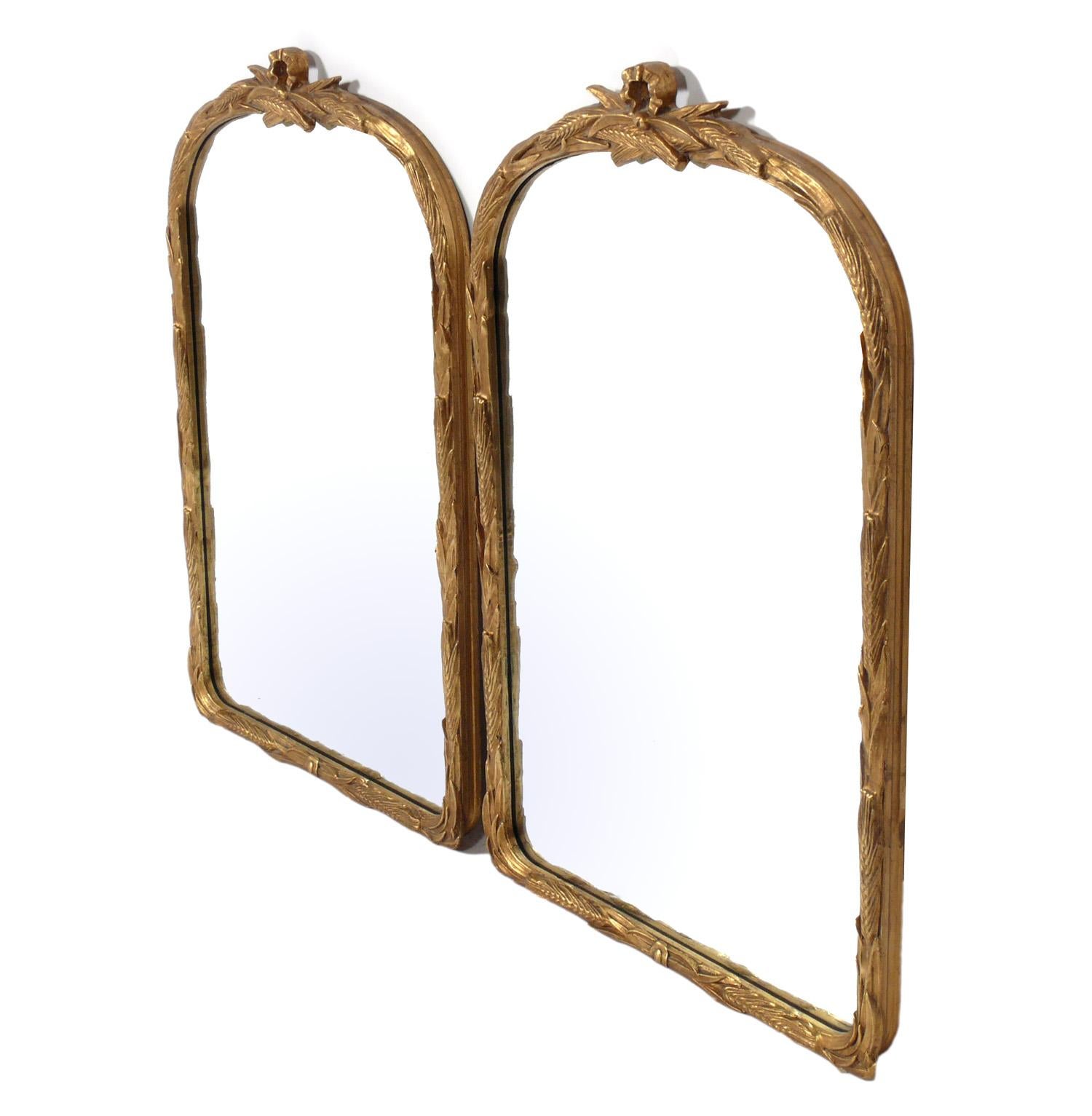 Pair of gilt French mirrors, France, believed to be 1940s, possibly earlier. They retain their warm original patina to the giltwood frames and the original mirrored glass. They are priced at $2900 for the pair, or $1800 each.