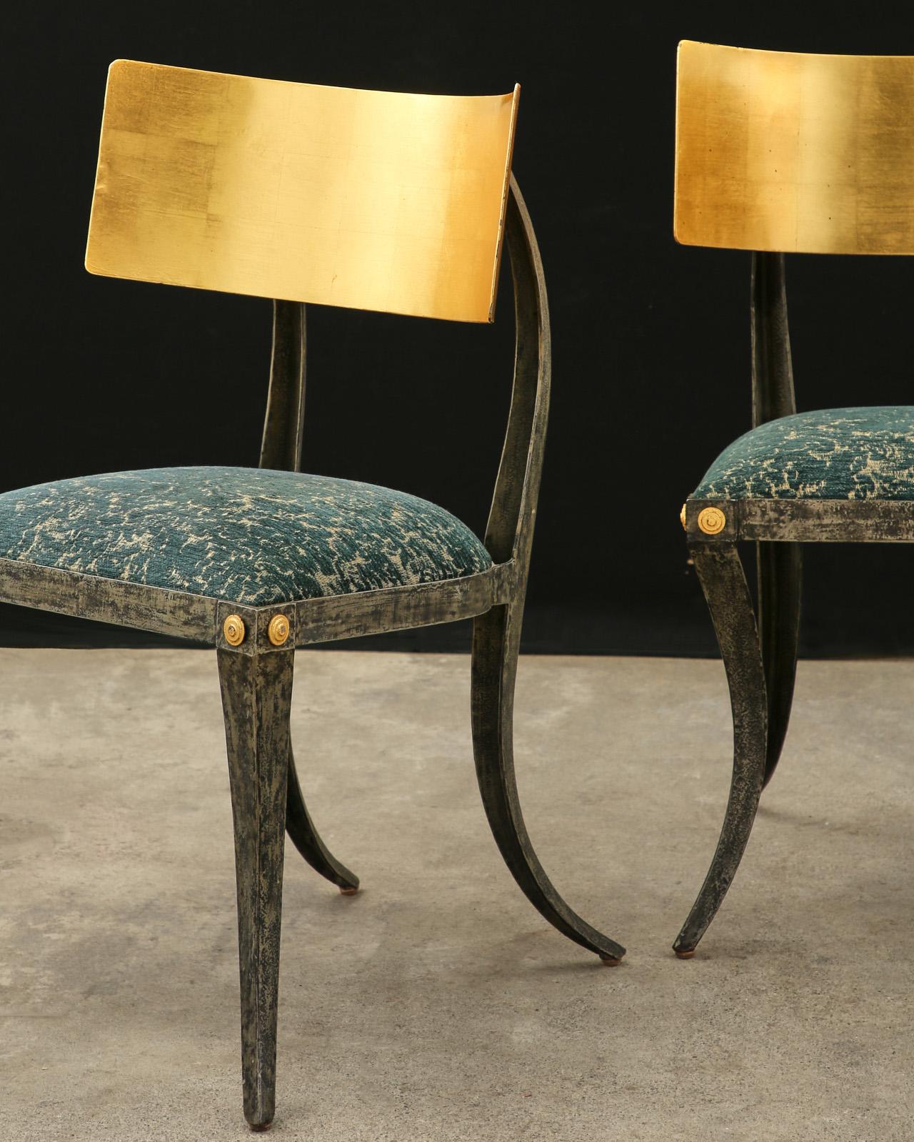 Dramatic pair of klismos chairs designed by Ched Berenguer-Topacio. The sinuous chairs feature a wrought iron frame with a large curved tablet back embellished with gold leaf squares. The gracefully curved legs support an upholstered seat. Classic