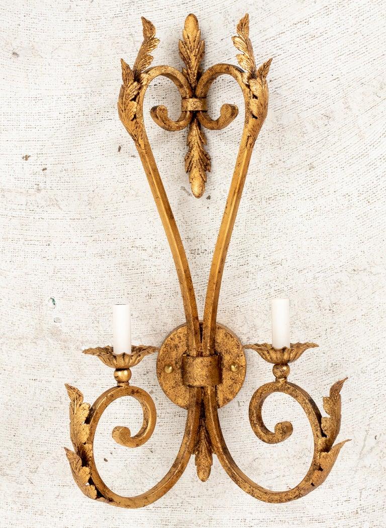 Pair of Large Scale Hollywood Regency gilt iron sconces with two arms each. Sconces are handmade in Miami Lakes, FL by 