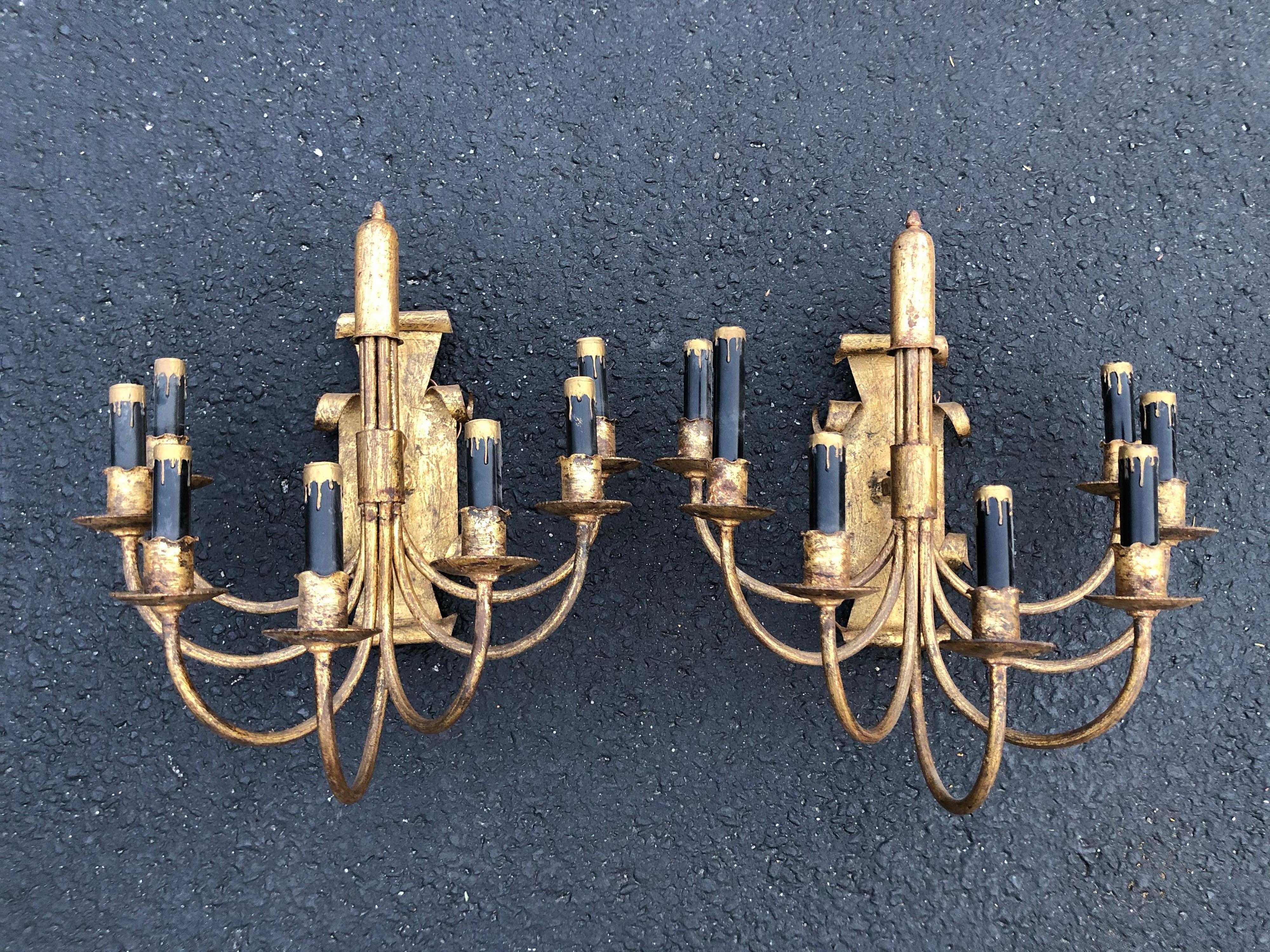 Pair of gilt iron sconces with black candle covers.( Price is for thte pair of 2). Extremely elegant and sophisticated pair of Hollywood Regency sconces. Newly wired.