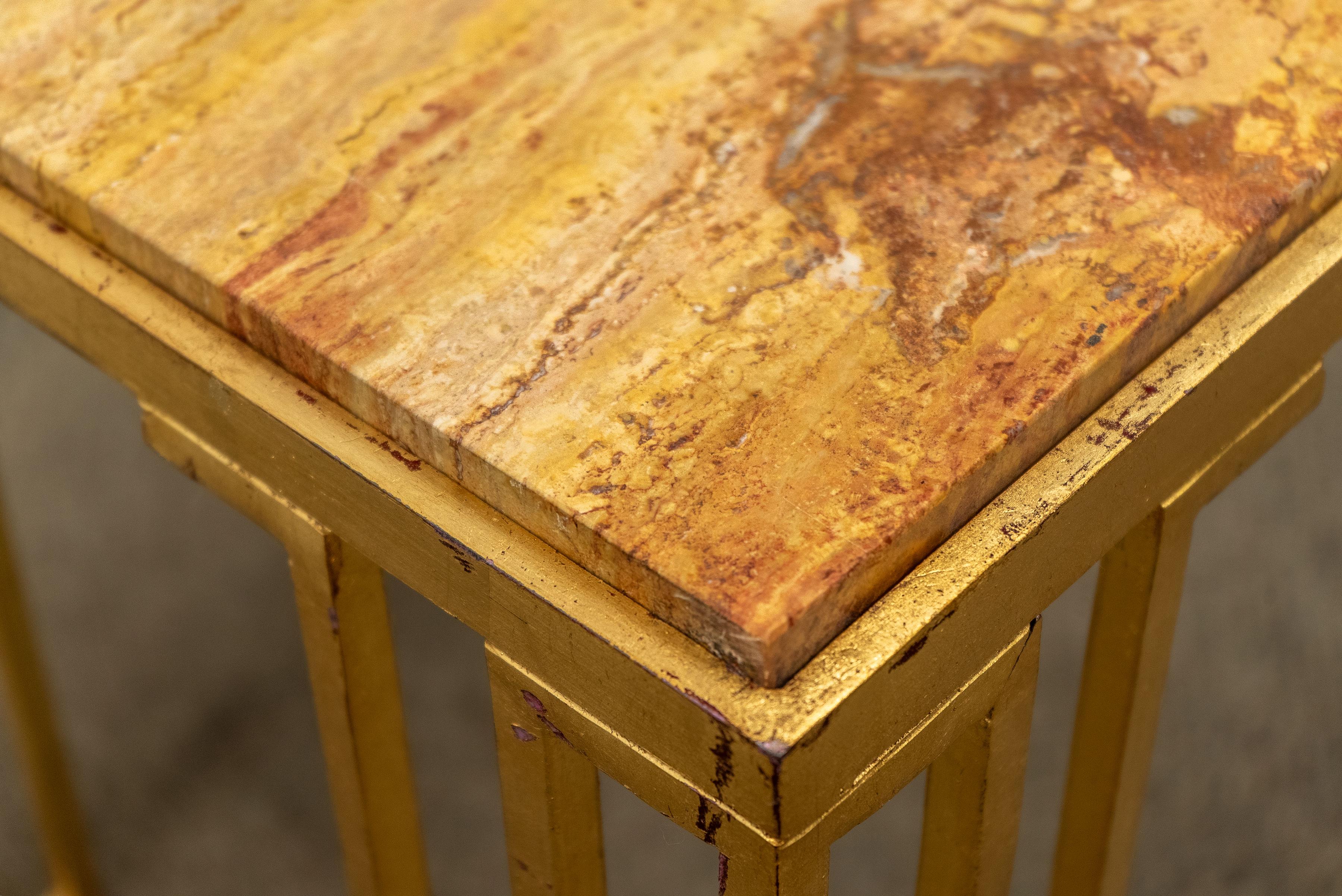 Pair of vintage French gilt iron end tables with inset travertine tops. These tables are in the style of Jean Royere's 