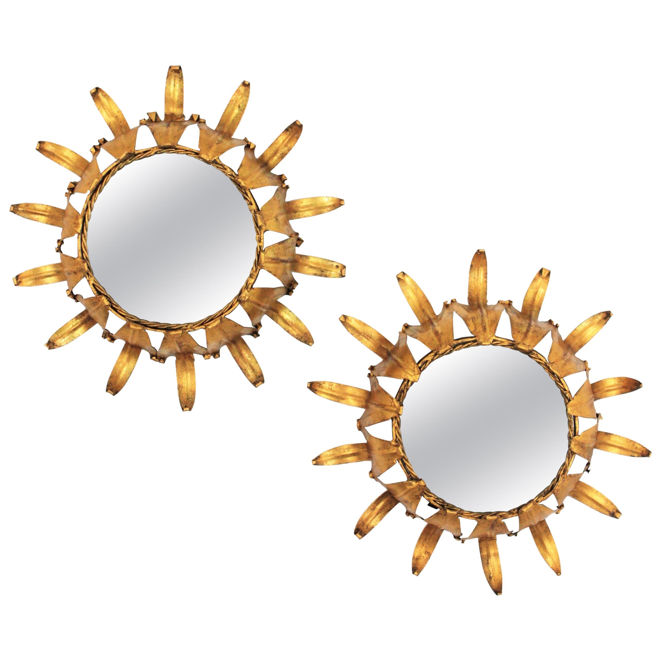 Beautiful pair of hand-hammered gilt iron leafed sunburst mirrors in small size, Spain, 1950s.
Lovely to place together or as a wall composition with other sunburst mirrors in different sizes to add a Hollywood Regency taste to any room.
Overall