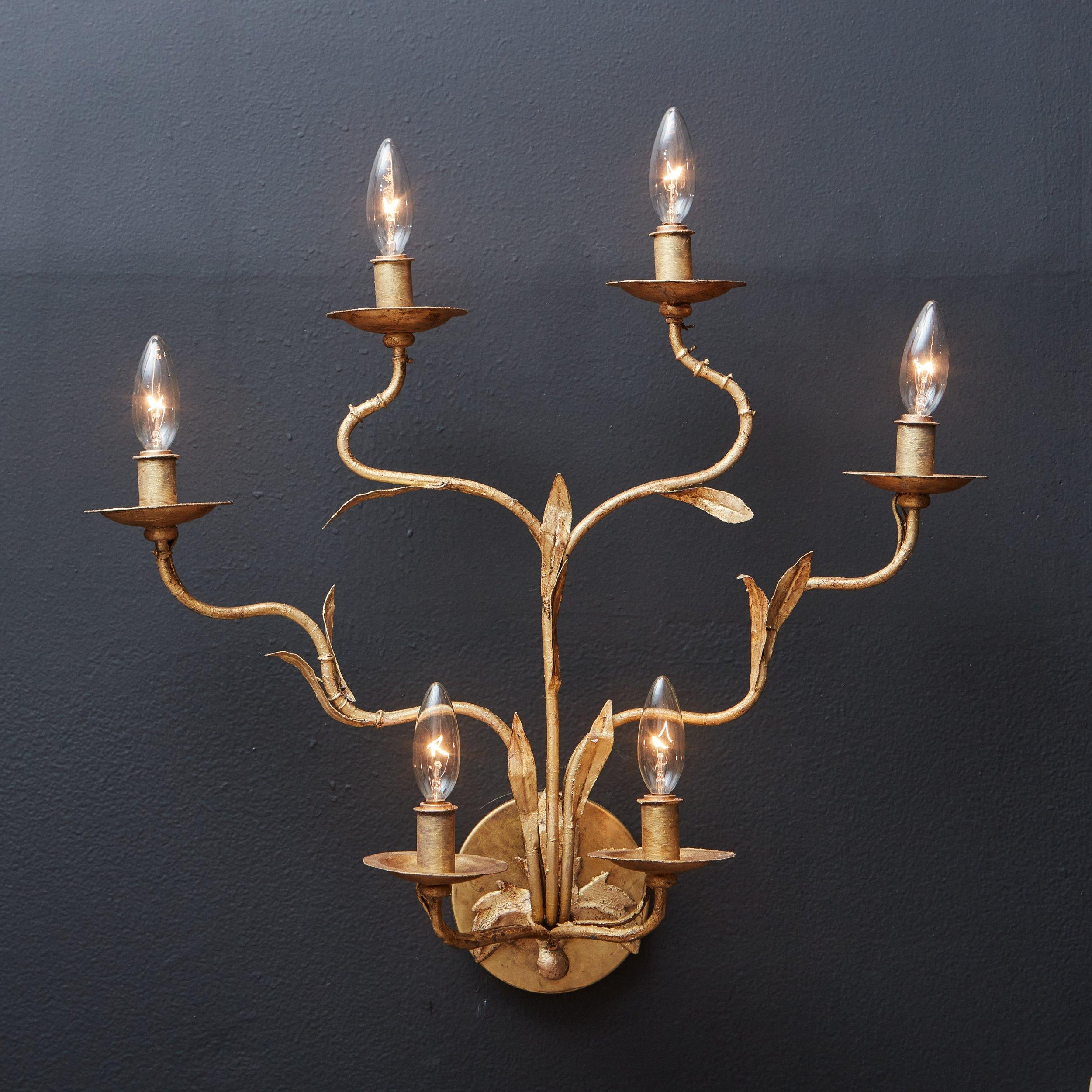 A pair of 1960s Italian sconces featuring six curved arms with leaf detailing, reminiscent of a branch. Each arm has a bobeche and accepts one candelabra light bulb. These sconces were constructed with metal and have a stunning hand applied gold