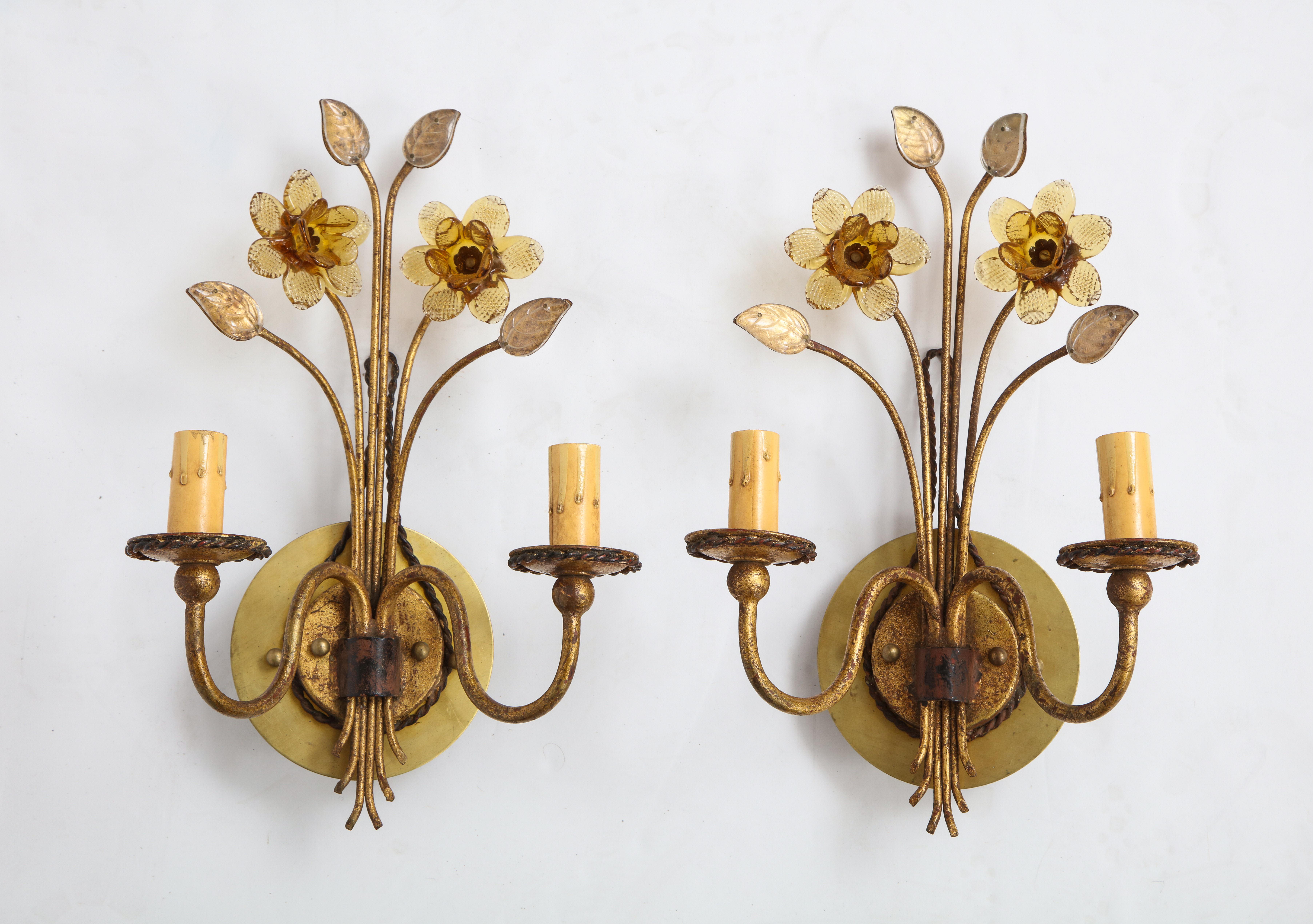 A precious pair of gilt metal sconces with daffodils and leaves of hand crafted glass