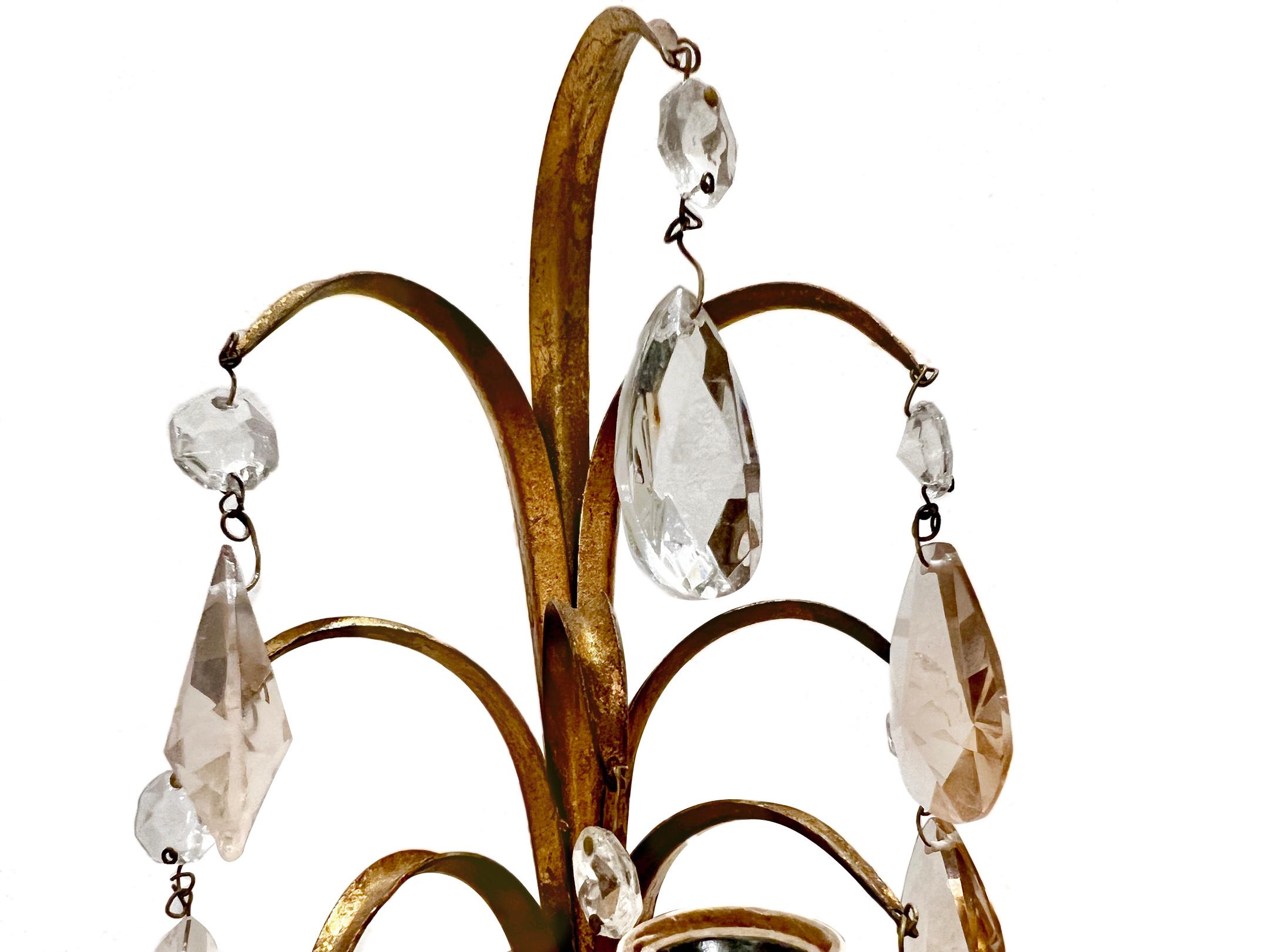 A pair of circa 1950's Italian gilt metal sconces with clear and rose-colored crystals, original patina.

Measurements:
Height: 14