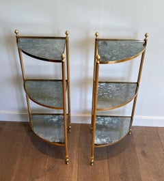 Pair of gilt metal corner side tables with eglomized mirror shelves. French work