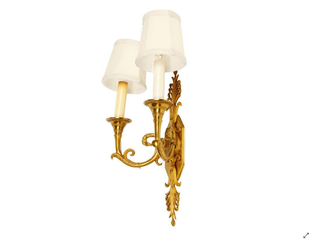 Gilt metal Empire sconces, two-arm, sold as a pair.
Measures: 11