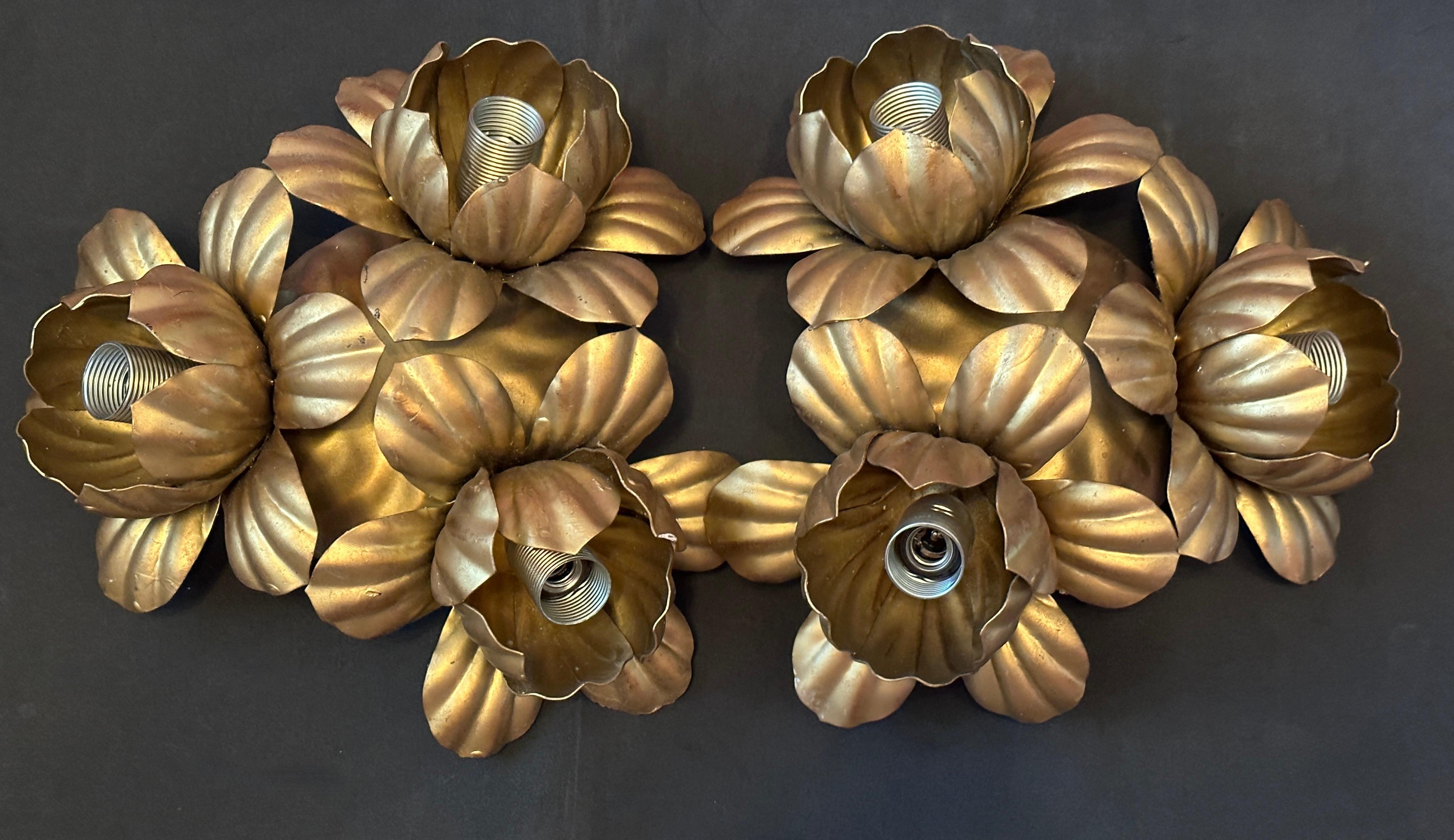 Add a touch of opulence to your home with this charming pair of flush mount. Perfect gilt metal leafs to enhance any chic or eclectic home. We'd love to see them hanging in an entryway as a charming welcome home. Built in the 1960s, attributed to