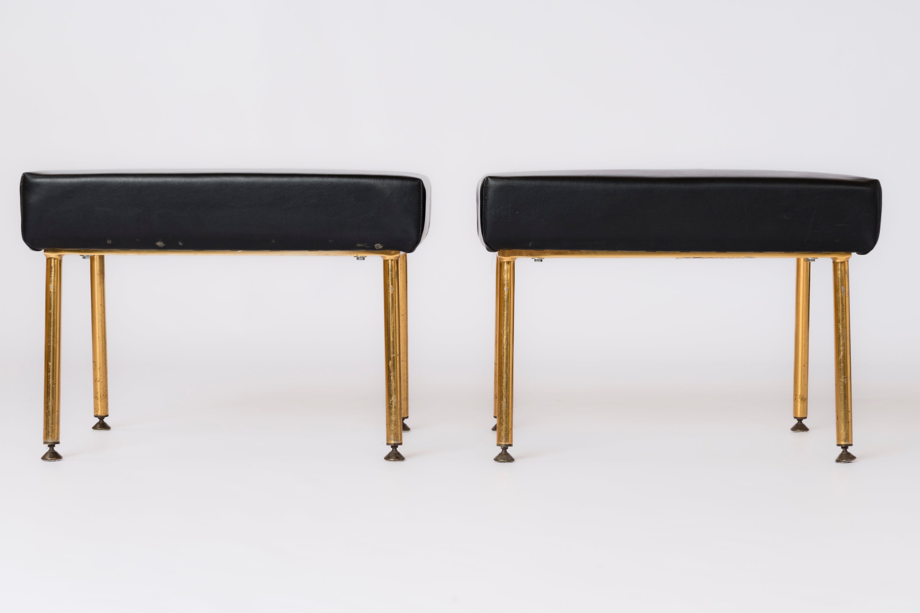 Pair of minimalist footstools or benches by Airborne, France, 1960's. Signed under cushions. These stools are made of steel frame sitting on a four gilt anodized legs structure.  The original cushions are made of black faux leather. COM option