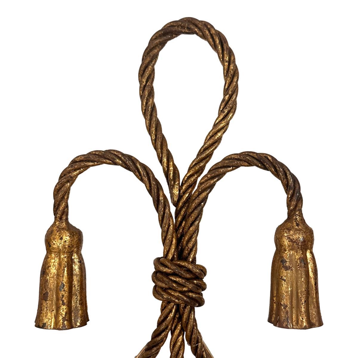 Pair of French circa 1960's gilt iron sconces with rope and tassel motif.

Measurements:
Height: 15