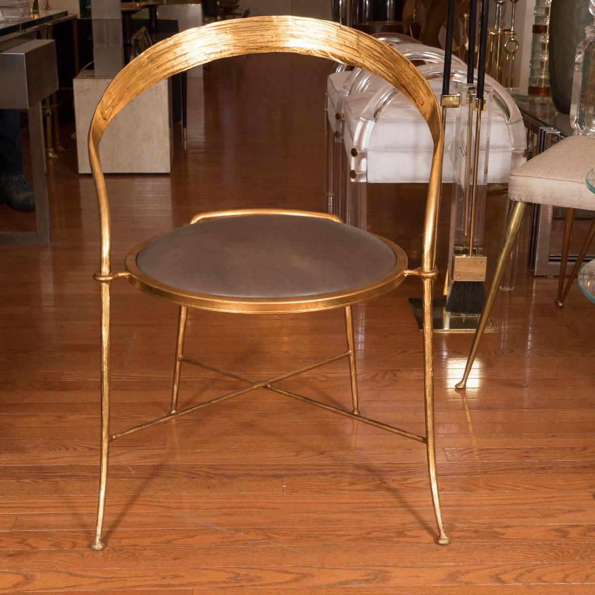 Pair of gilt metal, sculptural chairs with upholstered seats.