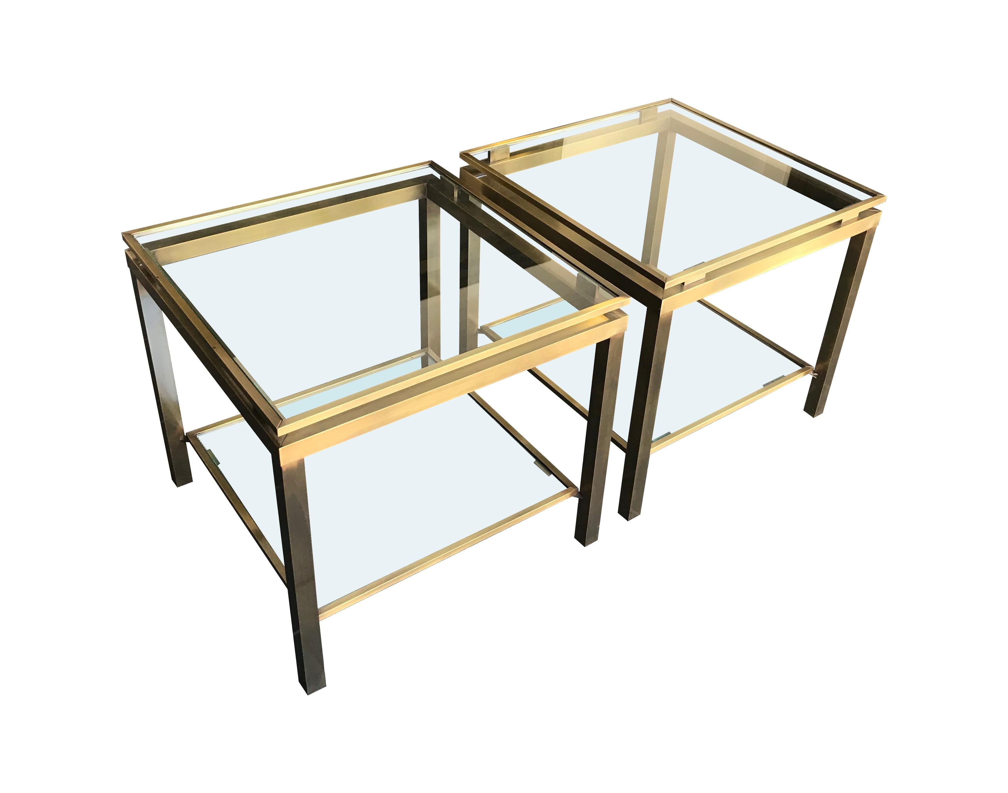 A pair of gilt metal side tables in the style of Guy Lefevre, each with two glass shelves.