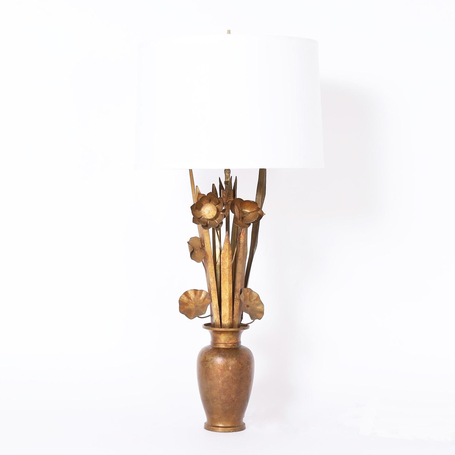 Chic vintage Italian table lamps crafted in metal with gilt finish having a stylized composition of flowers in a vase with the perfect combination of modern and classical influences.