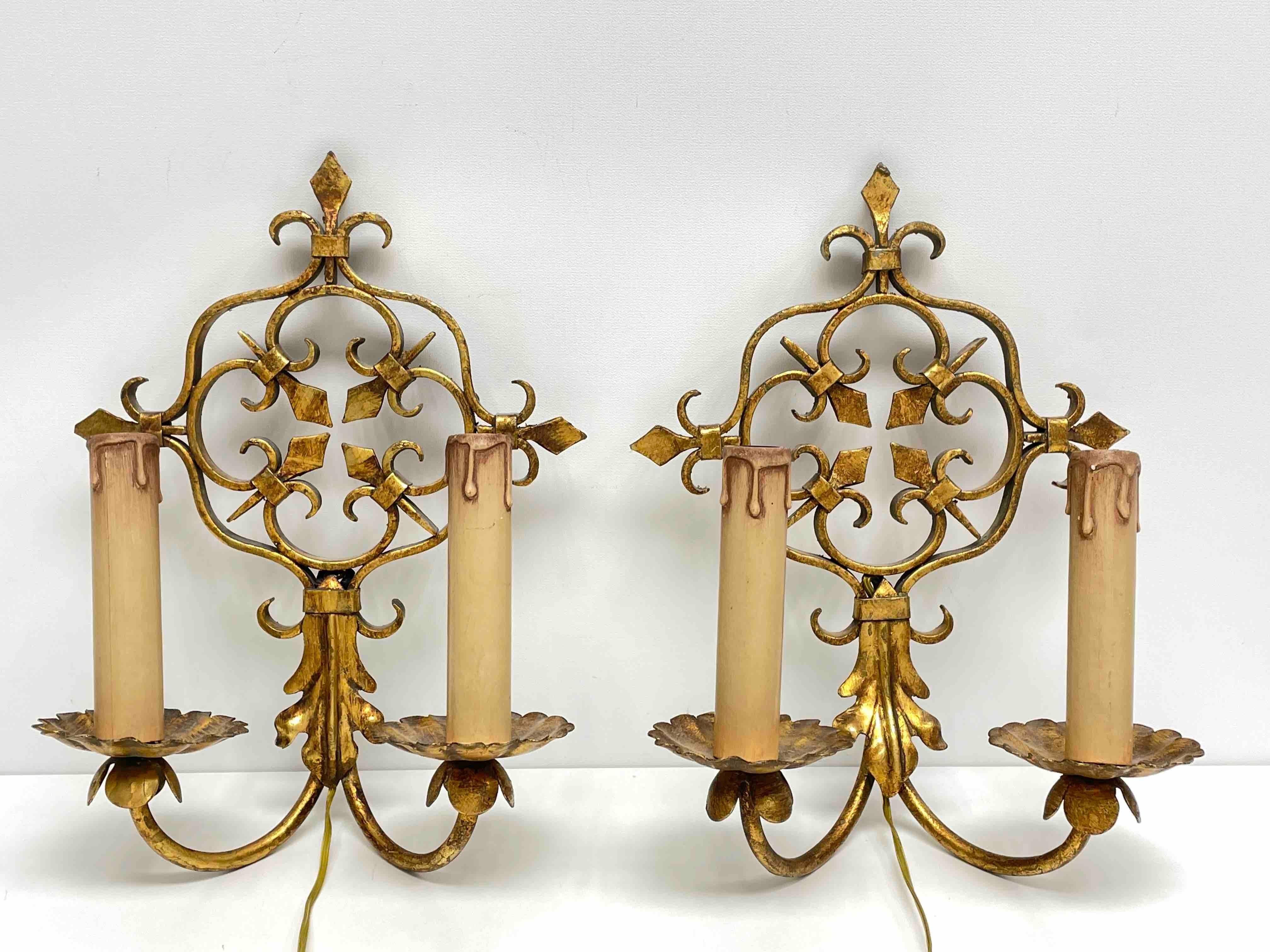 Add a touch of opulence to your home with this charming pair of sconces. Perfect gilt metal to enhance any chic or eclectic home. We'd love to see it hanging in an entryway as a charming welcome home. Built in the 1960s, in Italy, these sconces will