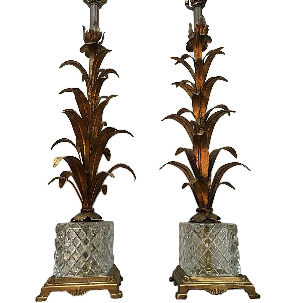 A pair of Italian, circa 1950s gilt metal palm tree lamps with a cut-glass and bronze base.
Measure: 21